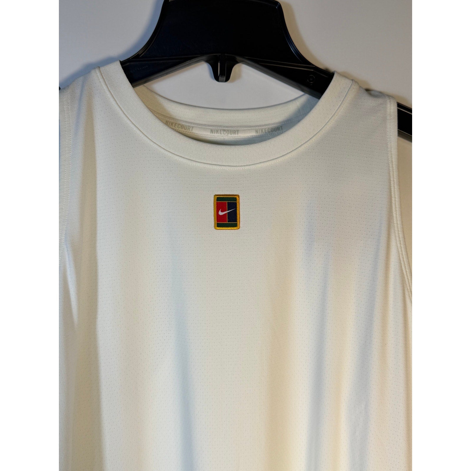 White NikeCourt Dri-FIT women's sleeveless tennis dress, size XL, shown on a model with athletic fit and sporty design.