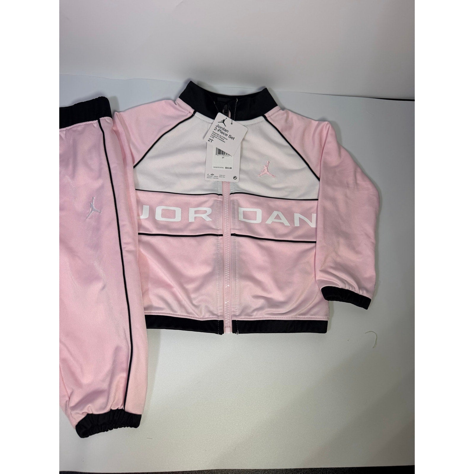 Jordan toddler girls pink and black 2-piece track jacket and pants set, size 2T, new with tags, casual athletic clothing.