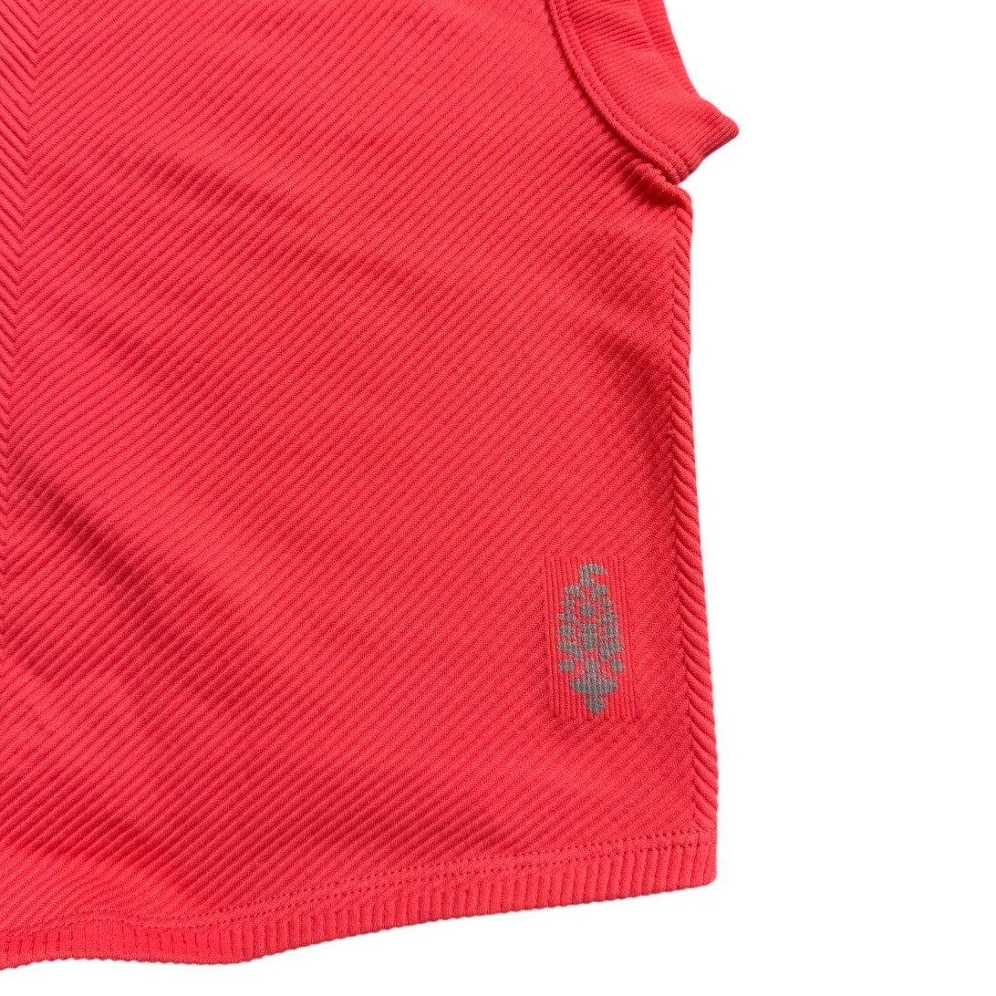 FP Movement coral pink ribbed cropped tank top, XS/S size, stylish performance workout top with fitted design.