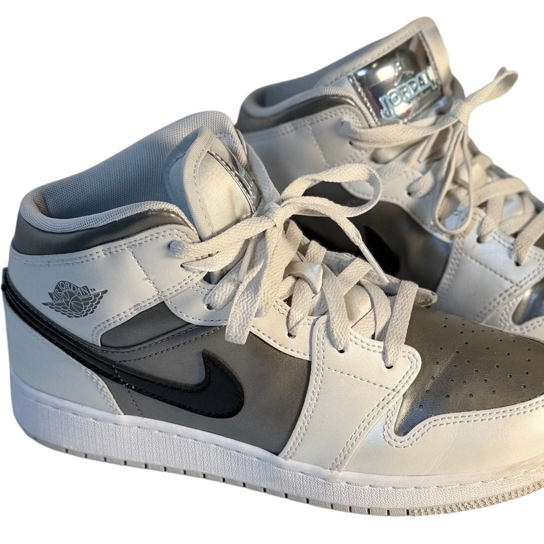 Air Jordan 1 Mid GS sneakers in white, gray, and black for youth size 7Y, featuring iconic Jordan design and high-top style.