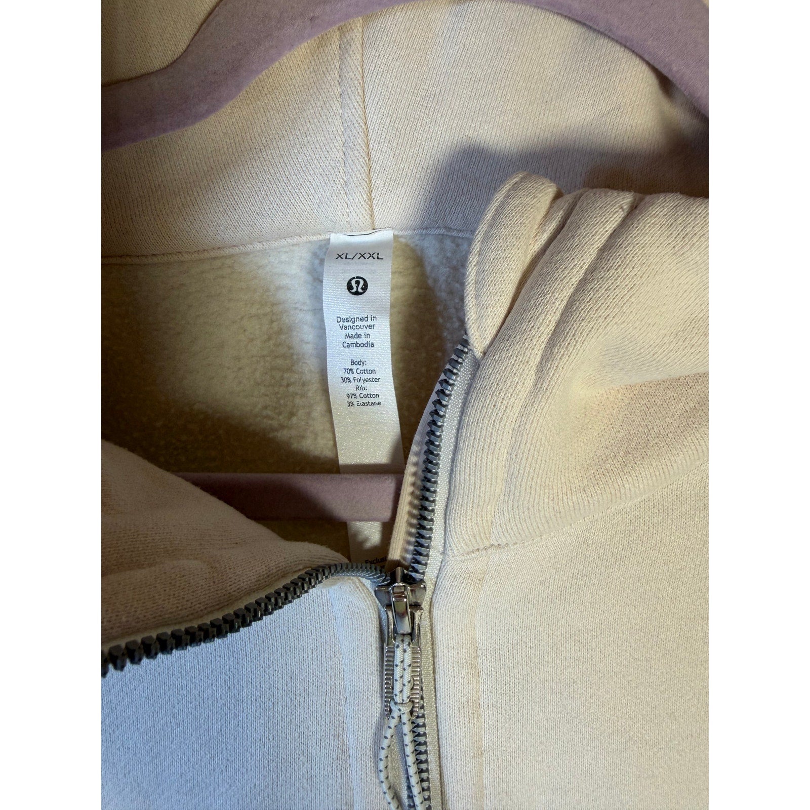 Lululemon women's cream Scuba half zip hoodie, oversized pullover in XL/XXL, displayed on a hanger with a cozy, relaxed fit.