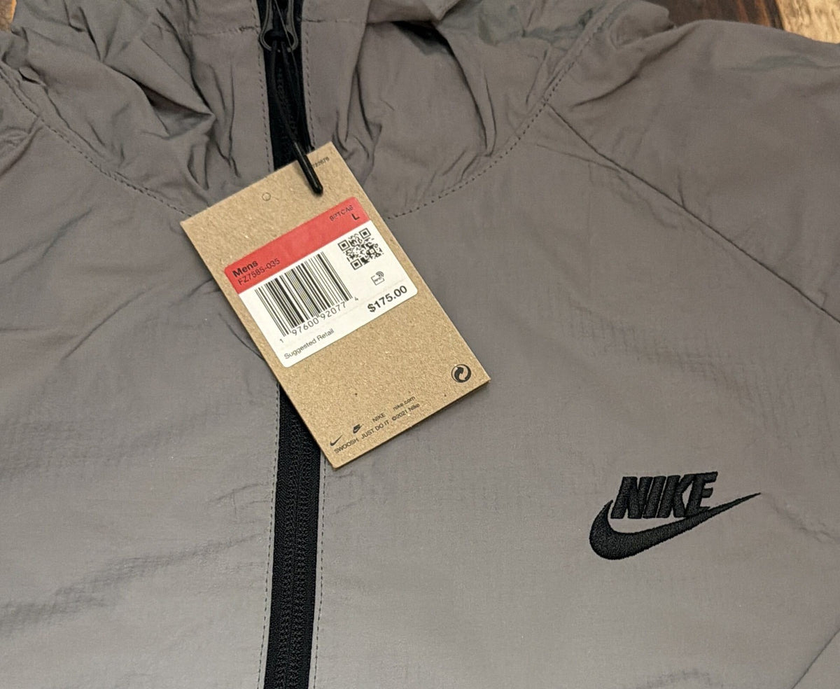Nike Tech Windrunner men's reflective full-zip hooded jacket in silver, size large, with Nike logo and windproof design.