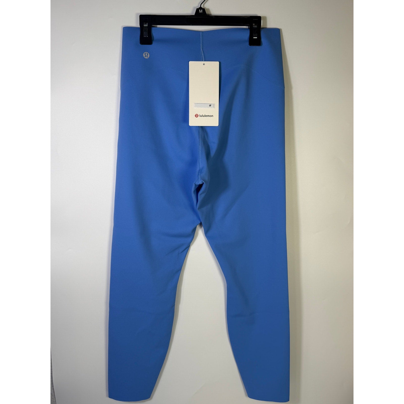 Lululemon Glow Up high-rise leggings in Pool Party Blue, size 14, showing the fitted, high-waisted design and vibrant color.