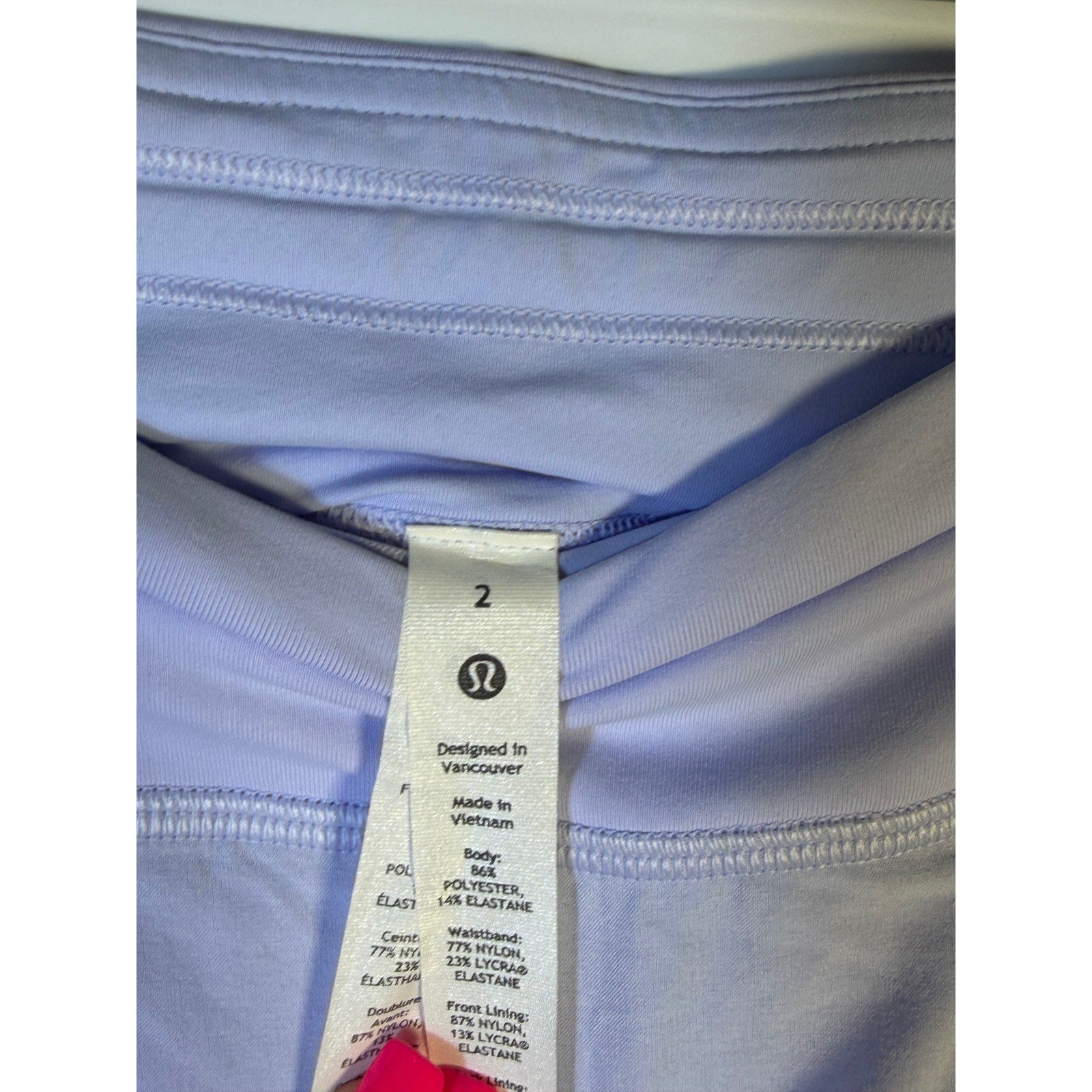 Light blue Lululemon women's tennis skort, size 2, athletic activewear skirt with built-in shorts and breathable fabric.