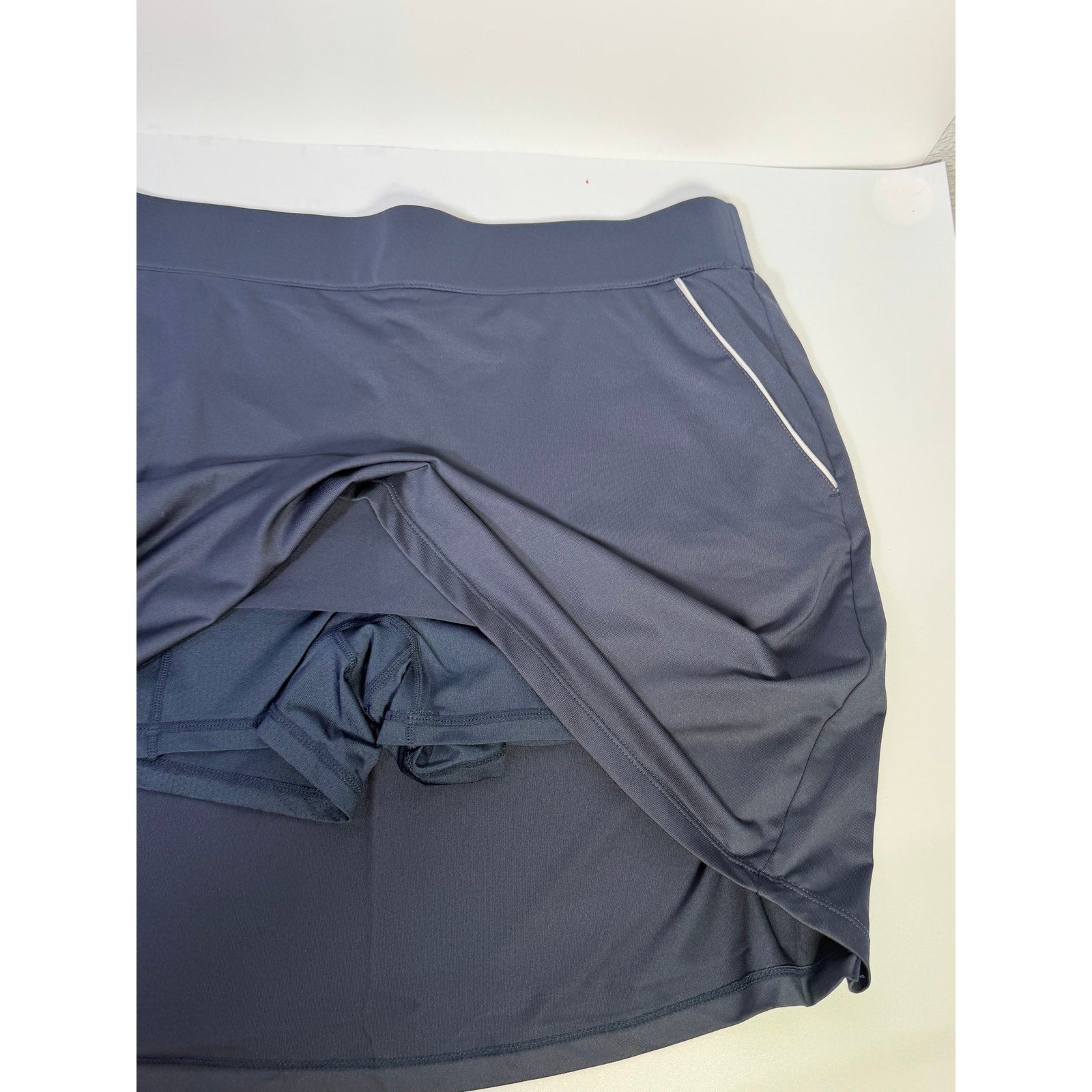 Dunning women's navy golf skort with built-in shorts, athletic style, size large, featuring a comfortable waistband and functional design.