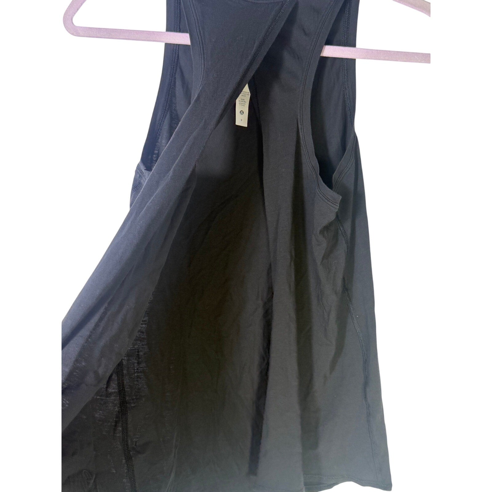 Lululemon women's black high-neck open-back athletic tank top, size 4, displayed on a hanger with a sleek, fitted design.