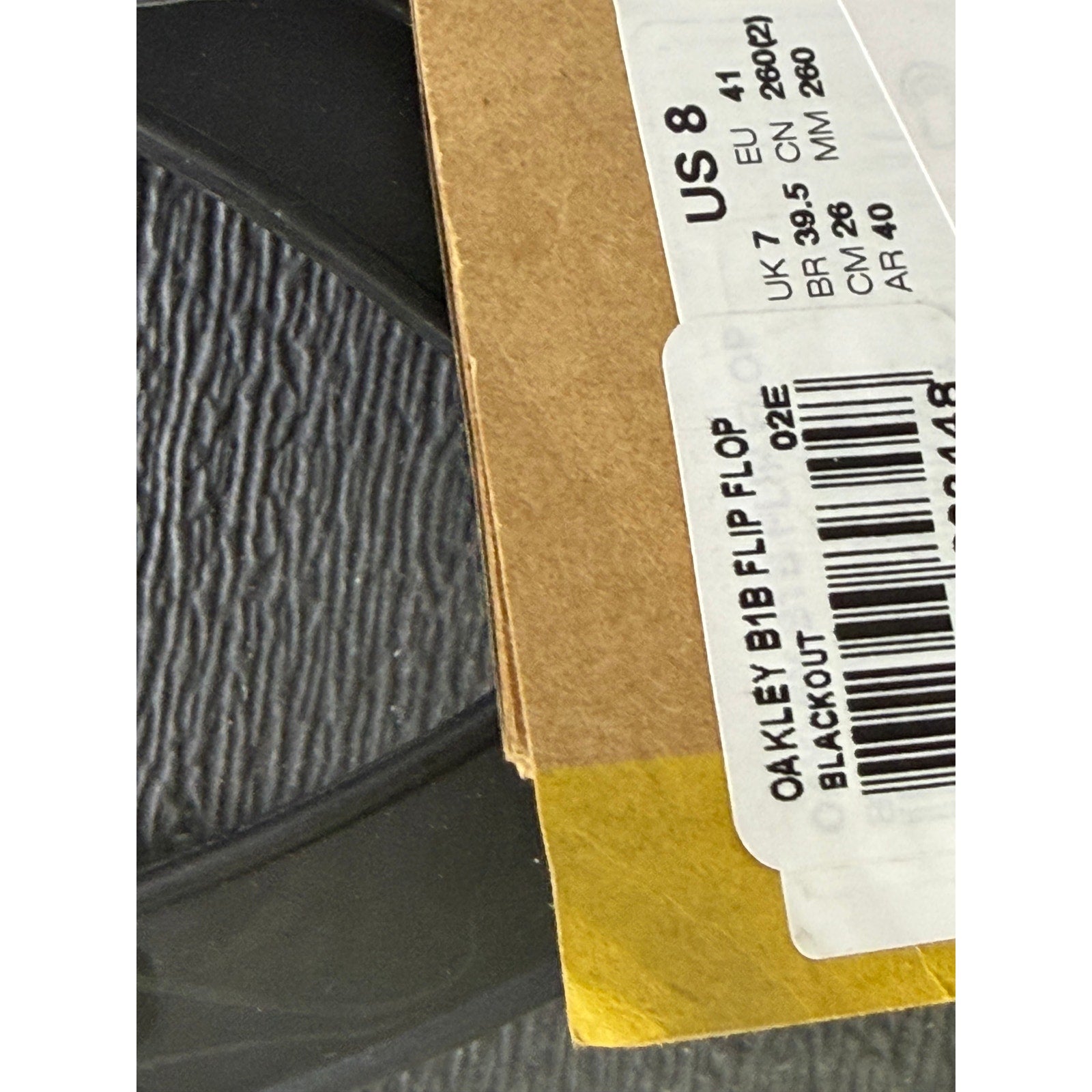 Black Oakley B1B flip flops for men, US size 8, showing the sandal's straps and footbed on a plain background.