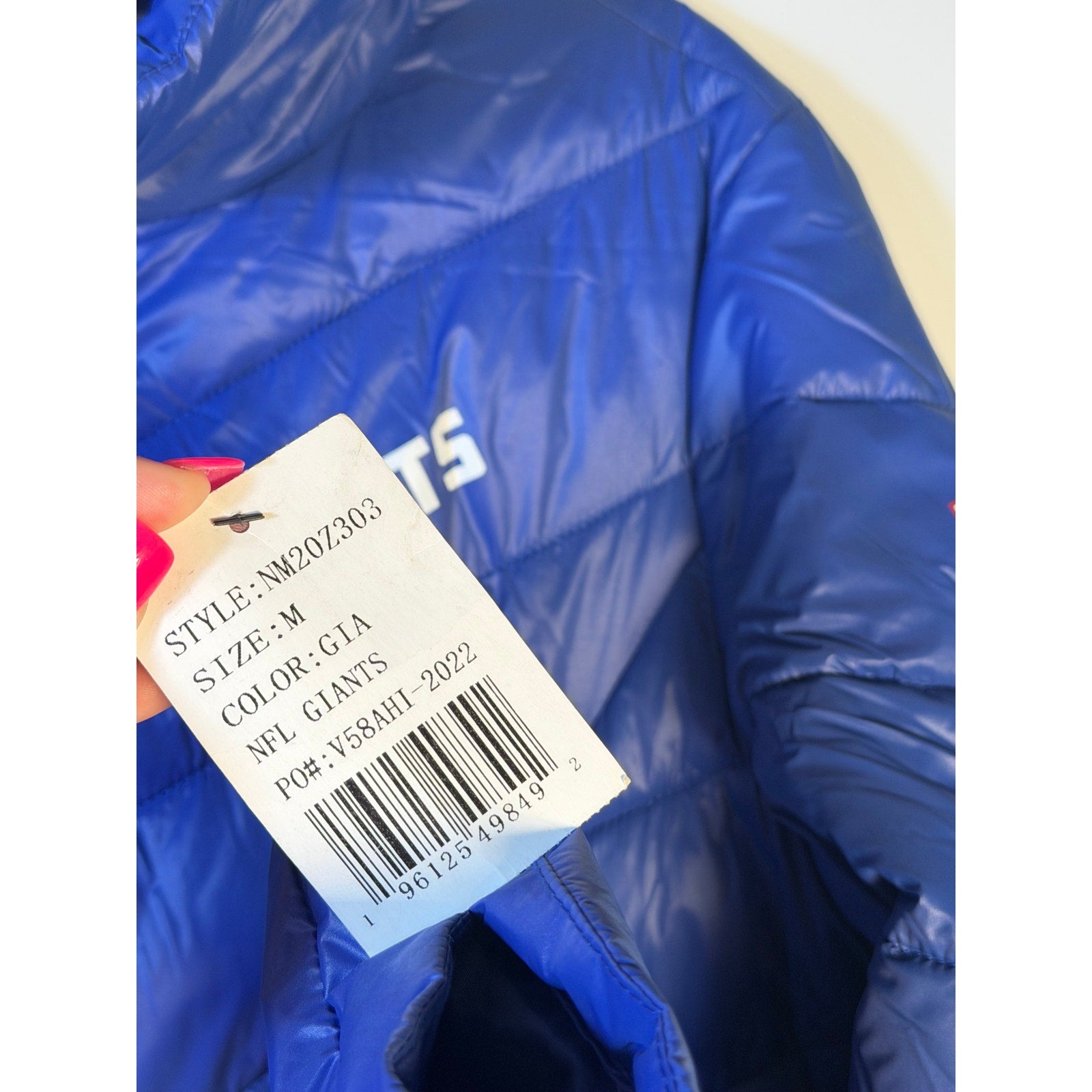 NFL New York Giants women's blue puffer jacket with full zip, medium size, featuring team logo and quilted design.