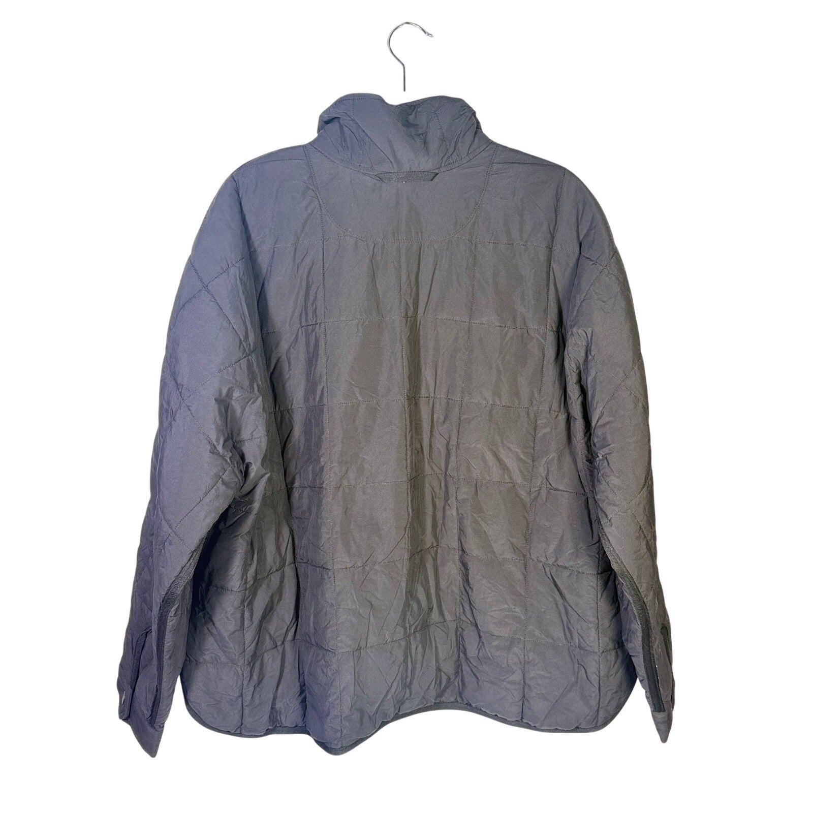 Black quilted Free People Movement women's full zip jacket in size large, displayed on a hanger with a stand.