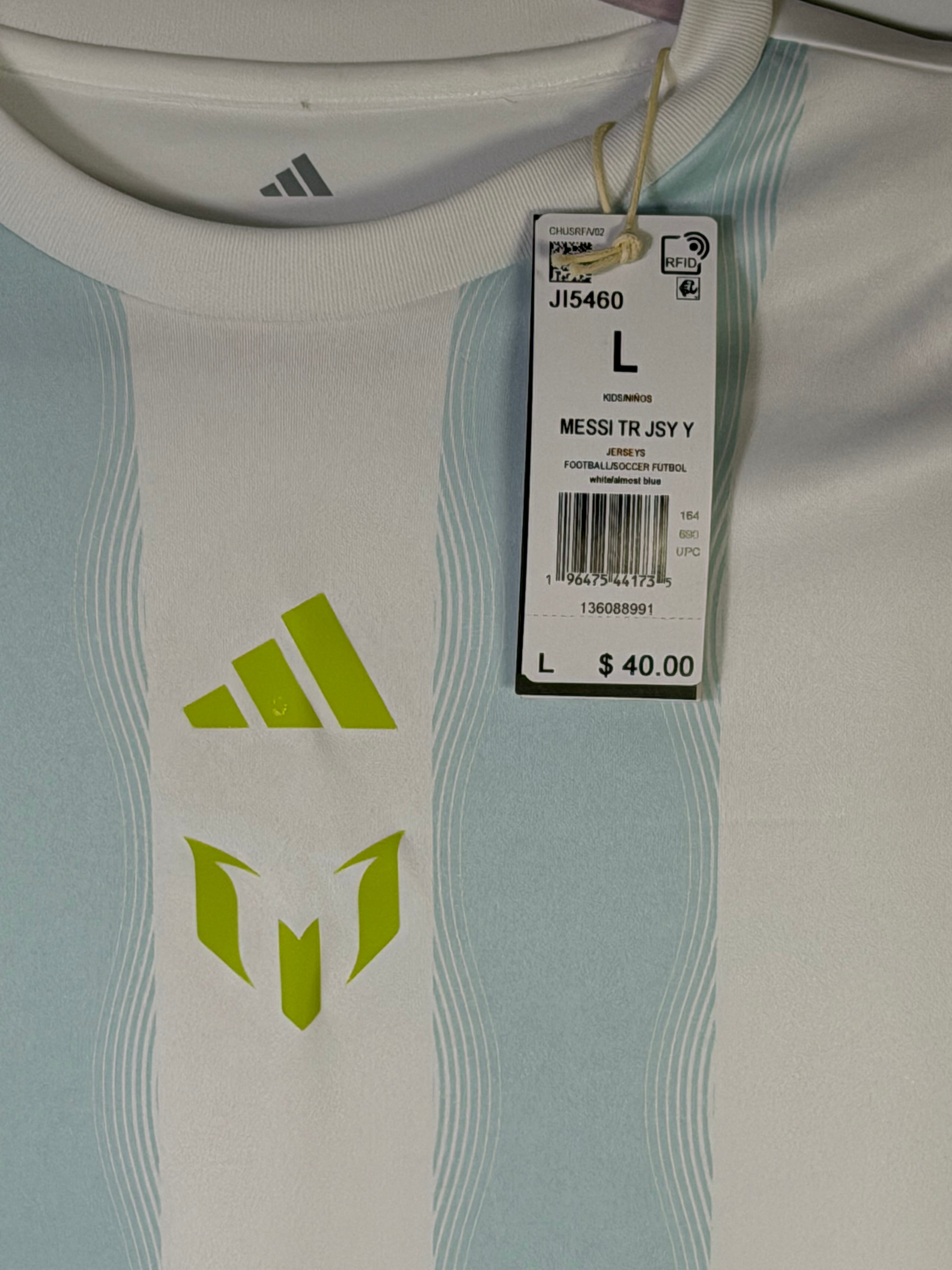 White Adidas Messi training jersey in size L, features the Adidas logo and Messi branding on the front, casual sportswear for active wear.