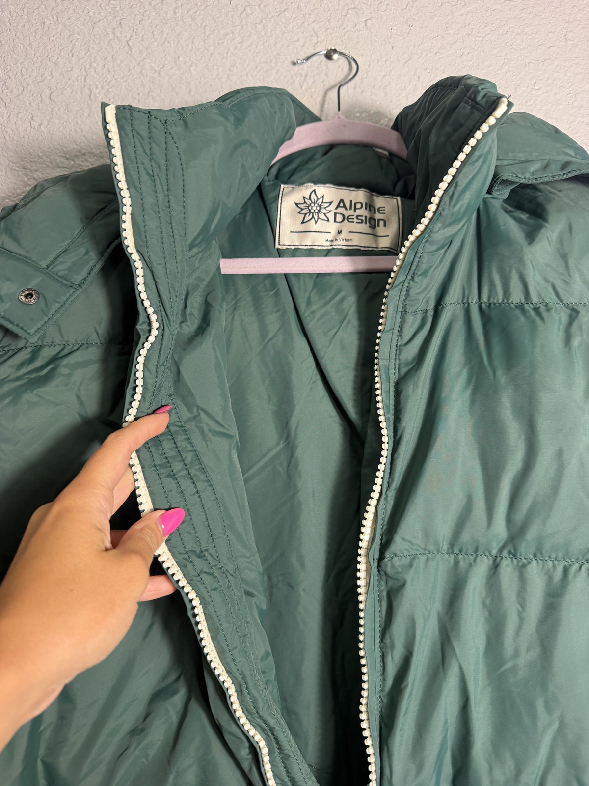 Green Alpine Design men's hooded puffer jacket, size M, showcasing the insulated, quilted design and attached hood.