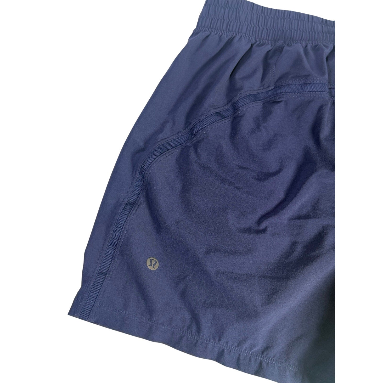 Lululemon men's navy blue athletic running shorts, size M, with lightweight fabric and elastic waistband, front view.