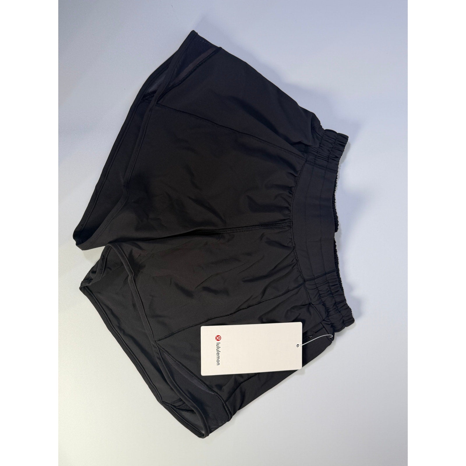 Black Lululemon Hotty Hot Low Rise Lined Shorts for women, size 4, featuring a 4-inch inseam and lightweight design.