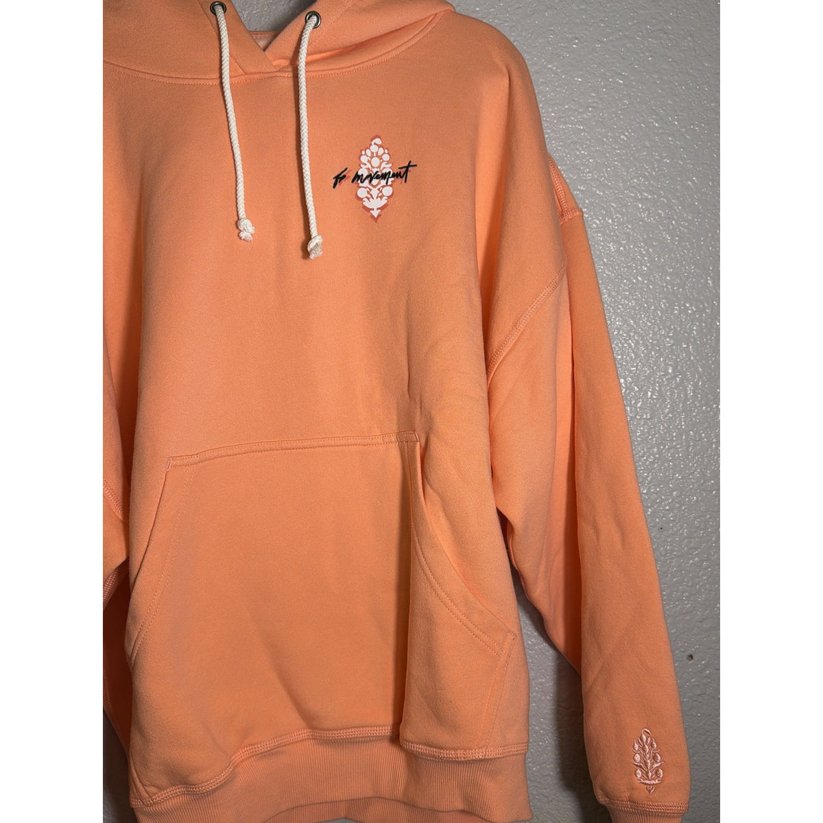 Women's oversized Free People FP Movement logo hoodie in fruit punch color, casual sweatshirt with bold logo design.