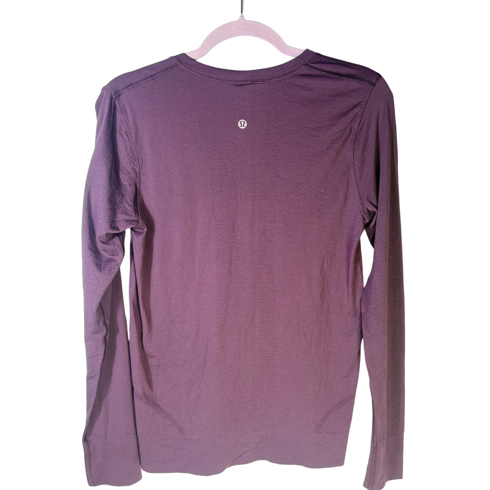 Lululemon women’s purple Swiftly Tech long-sleeve athletic shirt, size 6, made from lightweight, breathable fabric.