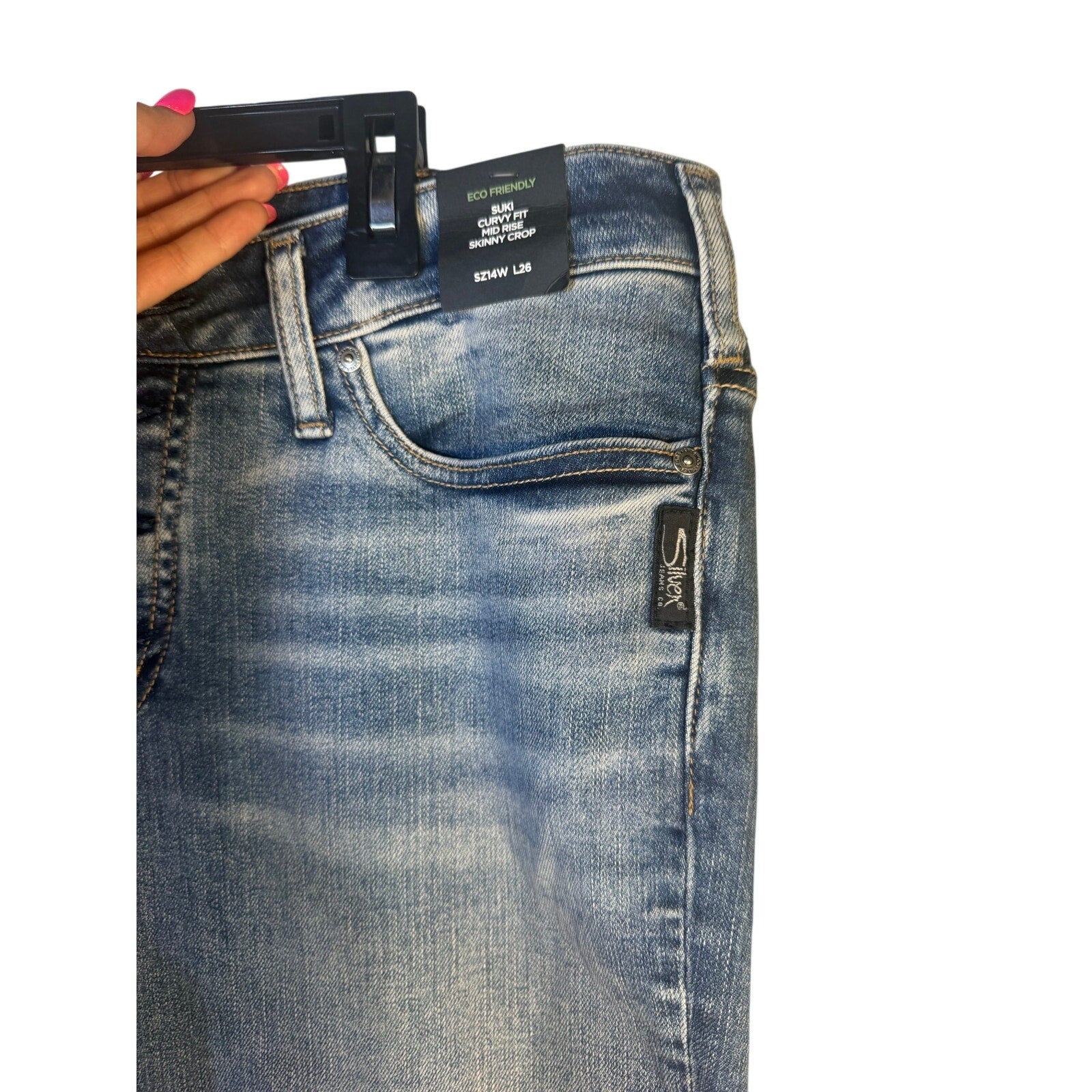 Silver Jeans Co. Suki curvy fit mid-rise skinny crop jeans for women, size 14W, shown in a natural pose.