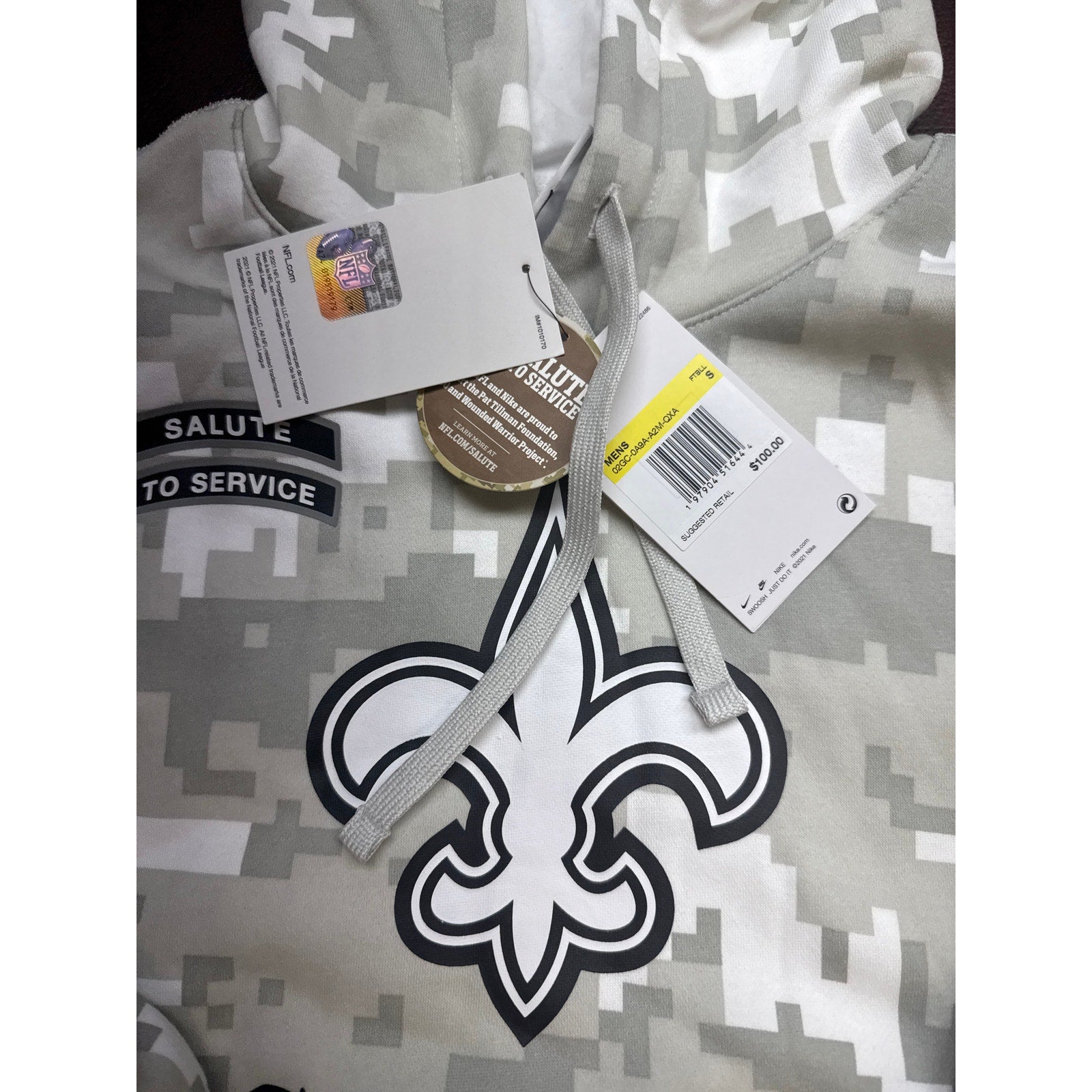Gray digital camo Nike NFL New Orleans Saints "Salute to Service" hoodie with team logo and military-inspired design.