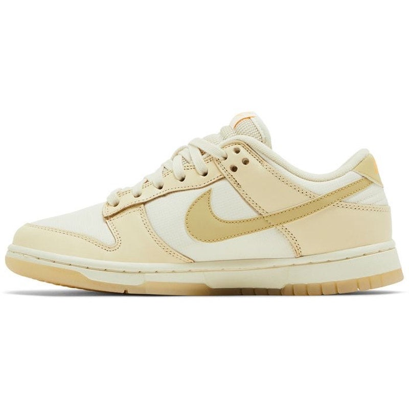 Nike Dunk Low women's sneakers in gold and white, size 6.5, featuring a classic low-top design and Nike branding.