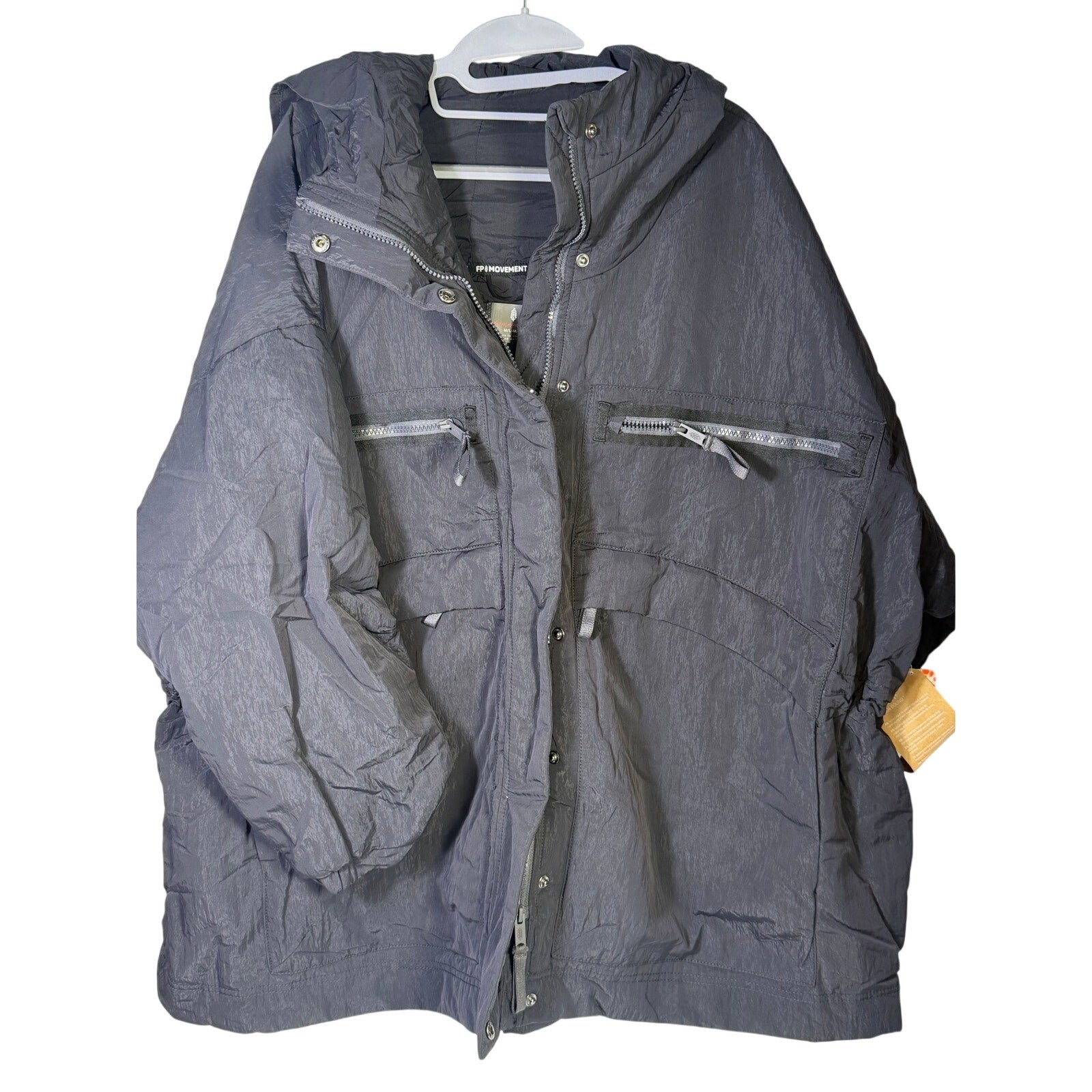 Black hooded utility jacket for women by Free People, featuring a hood, multiple pockets, and a casual fit.