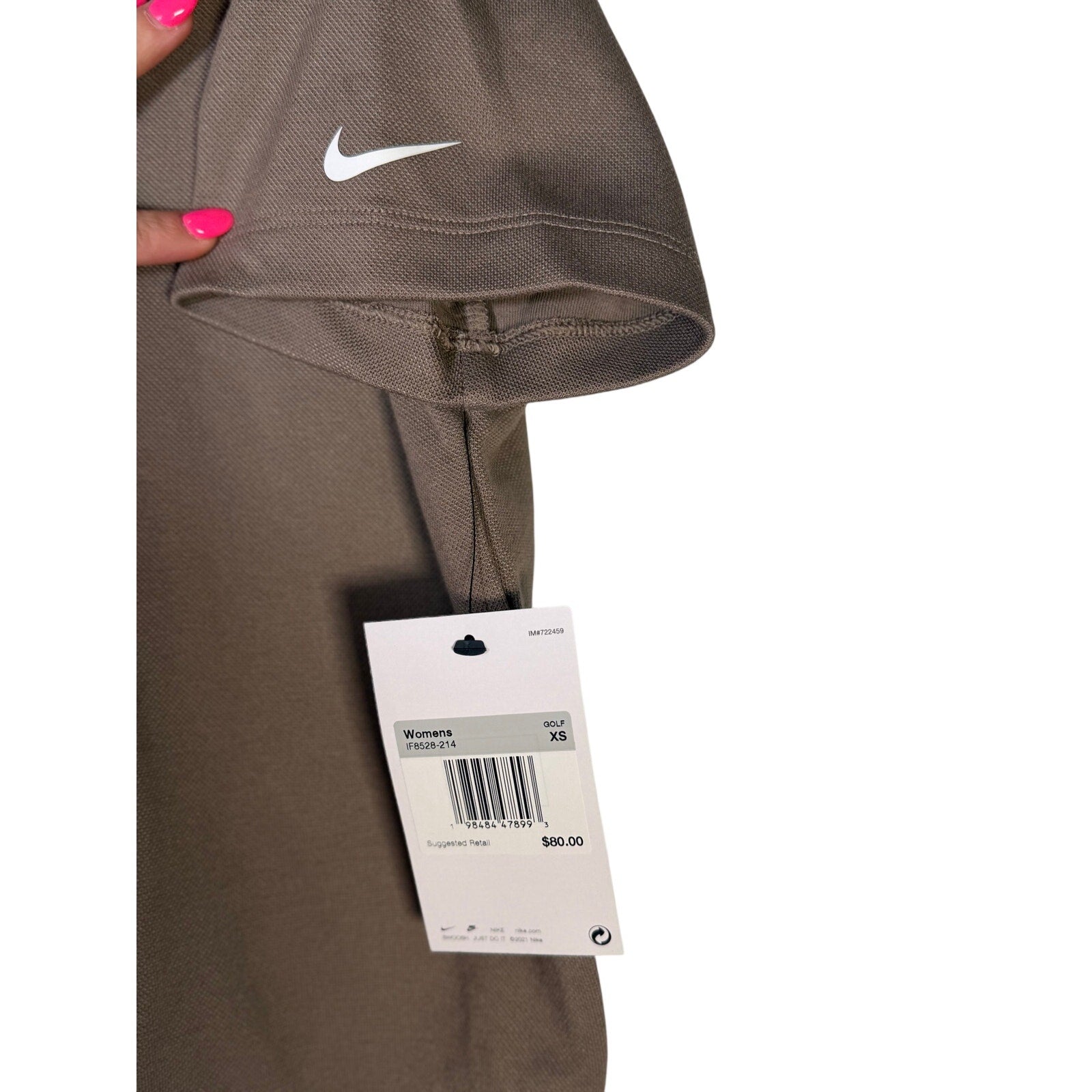 Nike women's short-sleeve golf polo in mink brown, size XS, displayed on a hanger with a collared design and Nike branding.