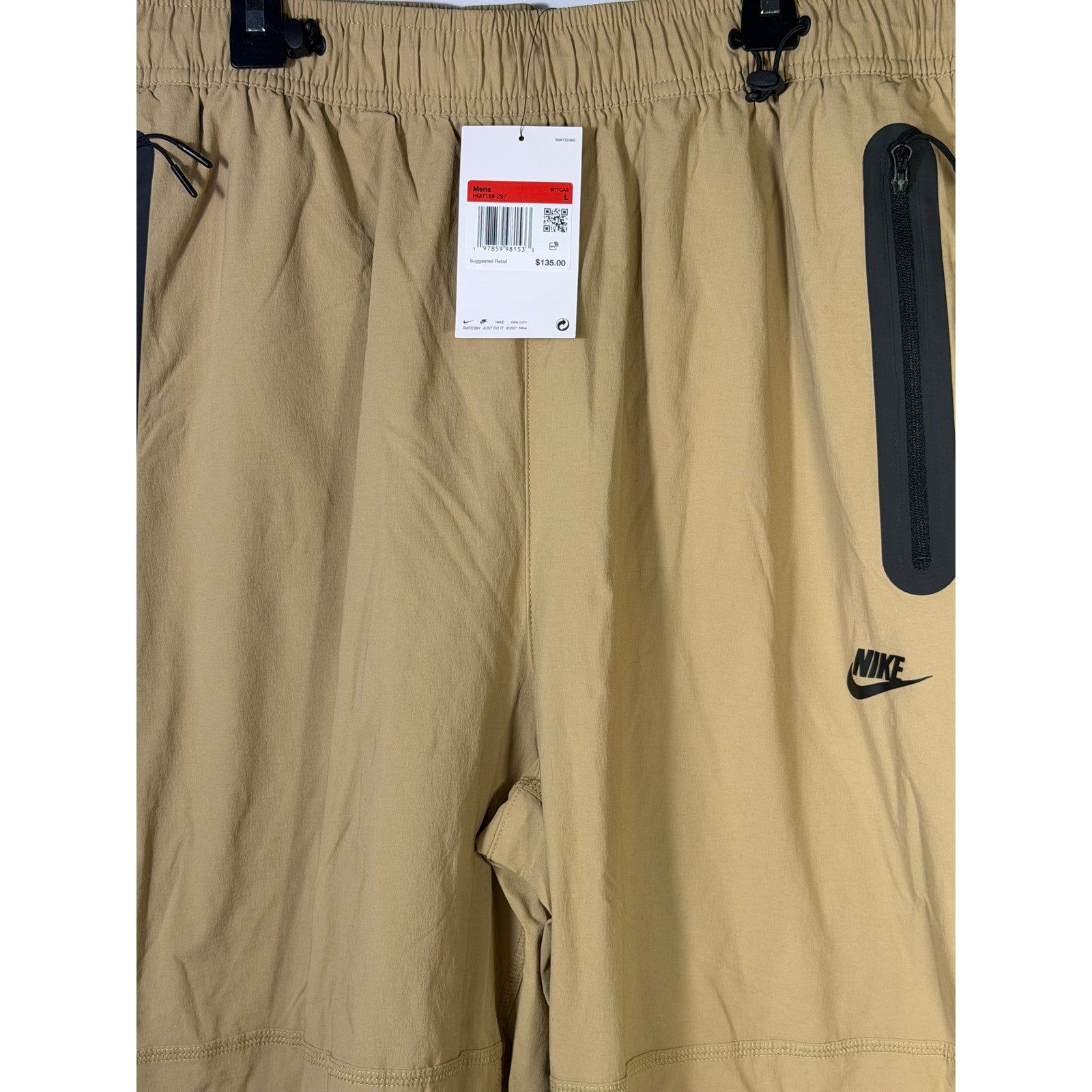 Nike Tech men's beige woven oversized parachute pants, size L, with relaxed fit and drawstring waist, new with tags.