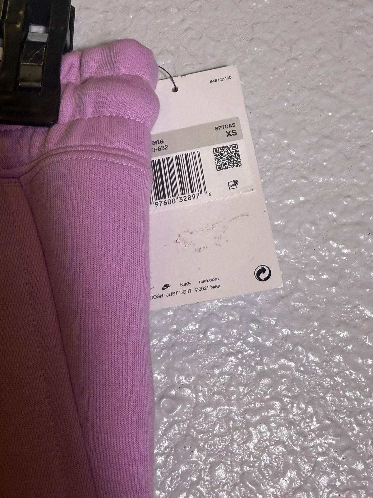 Nike Sportswear Tech Fleece joggers for women, size XS, pink mid-rise pants with a comfortable fit and sporty style.