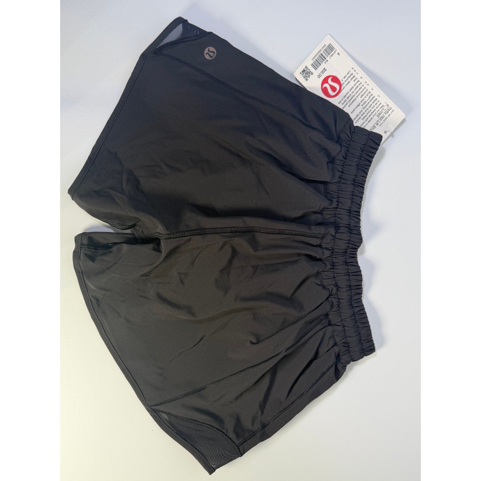 Lululemon Hotty Hot low rise lined shorts in black, women's size 4, showing the lightweight fabric and comfortable fit.
