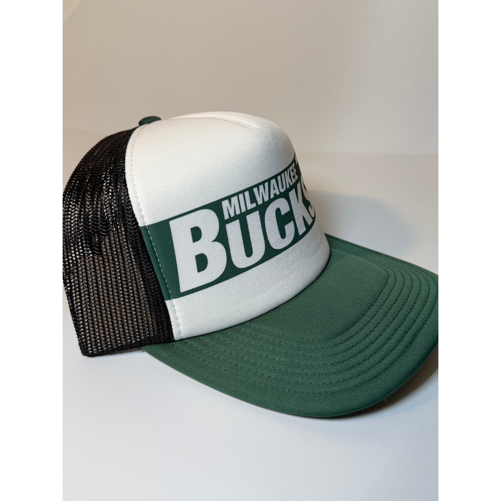 47 Brand Milwaukee Bucks trucker snapback hat in green and white, adjustable, featuring team logo and mesh back design