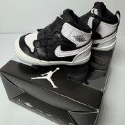 Nike Air Jordan 1 Retro High OG infant sneakers in black and white, designed for babies, featuring classic Jordan style and branding.