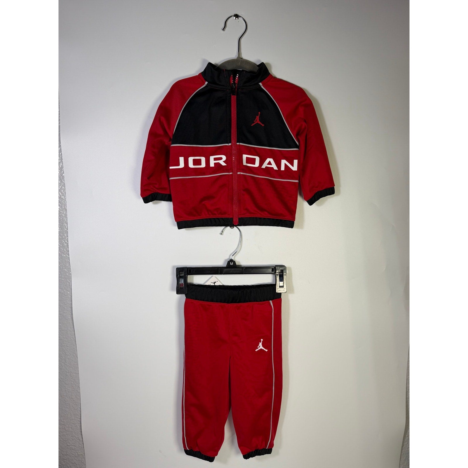 Jordan baby boys 2-piece red and black tracksuit jacket and pants set for 12 months, new with tags.