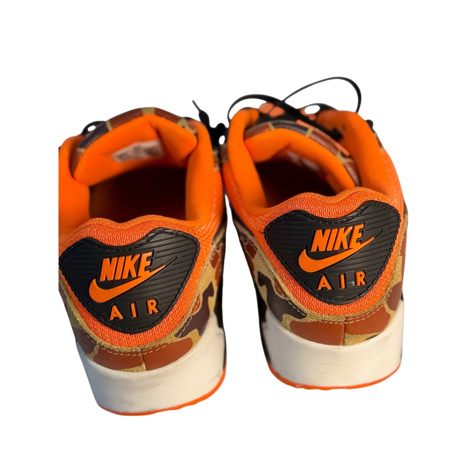 Nike Air Max 90 men's orange camo and black sneakers, side view showing the stylish design and branding.