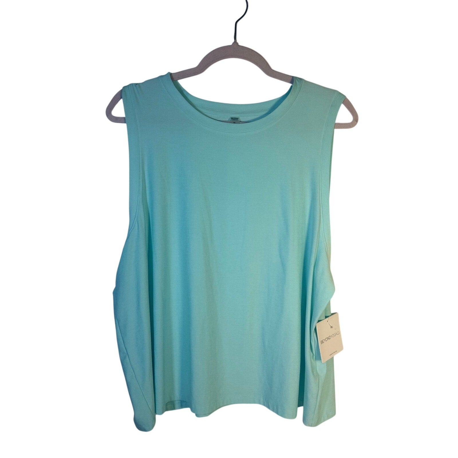 Beyond Yoga women's green sleeveless tank top, front view showing relaxed fit and soft fabric for activewear.