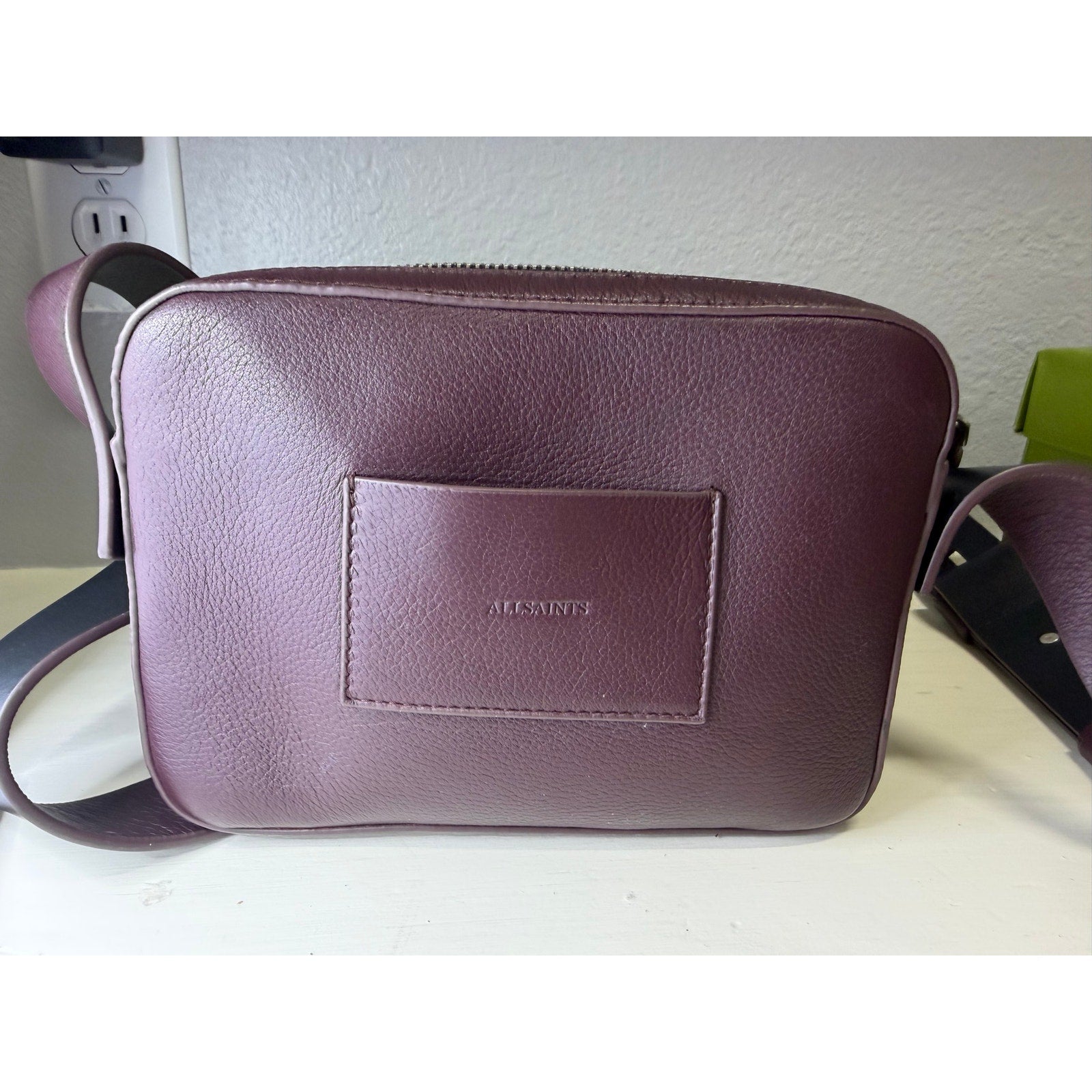 AllSaints women's burgundy pebbled leather camera crossbody handbag with adjustable strap and compact design