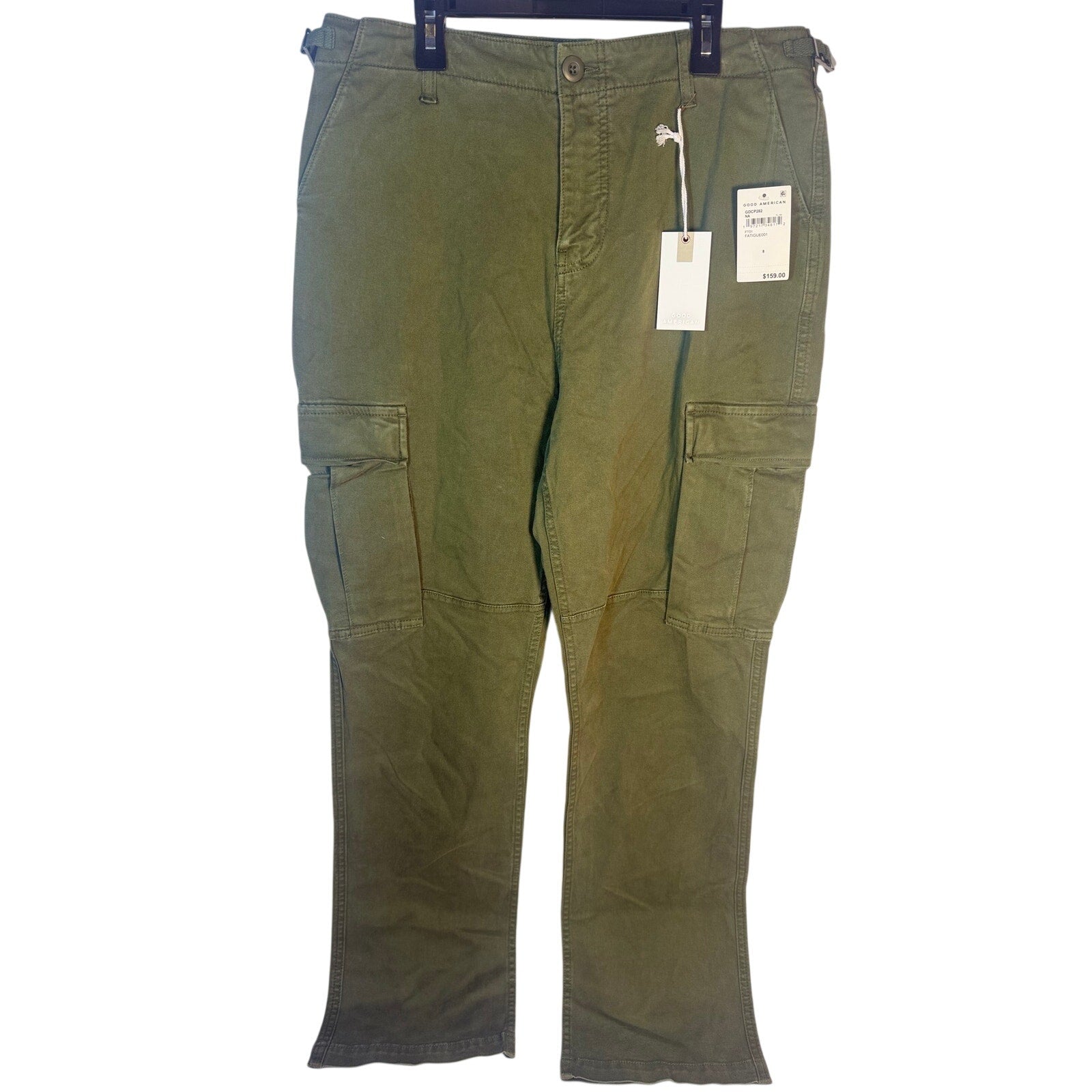 Olive green Good American fatigue cargo pants size 8 with multiple pockets, styled with a relaxed fit and casual design.