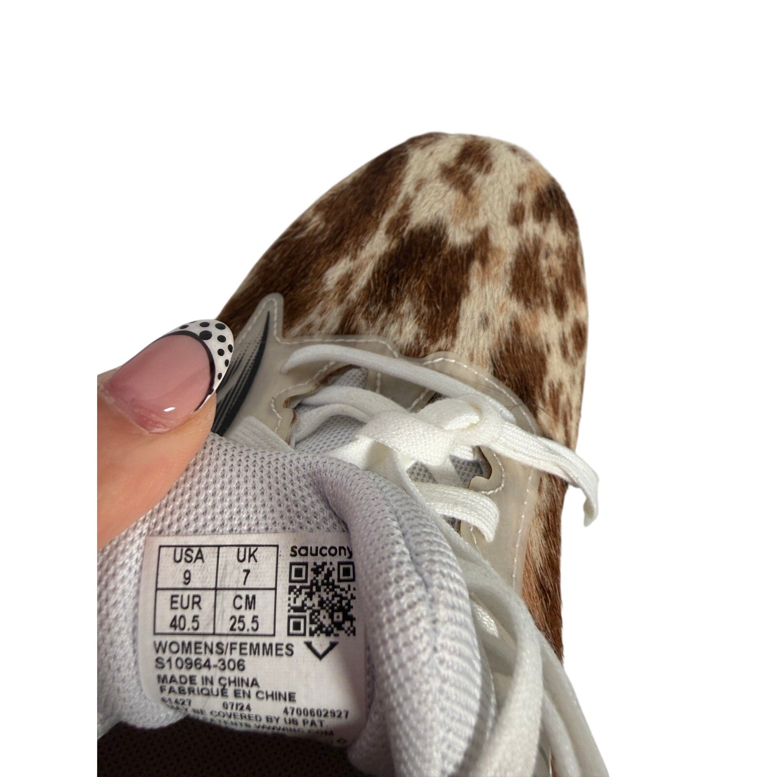 Saucony women's Endorphin Shift 3 Runshield cow print athletic running shoes, size 9, with black and white design.