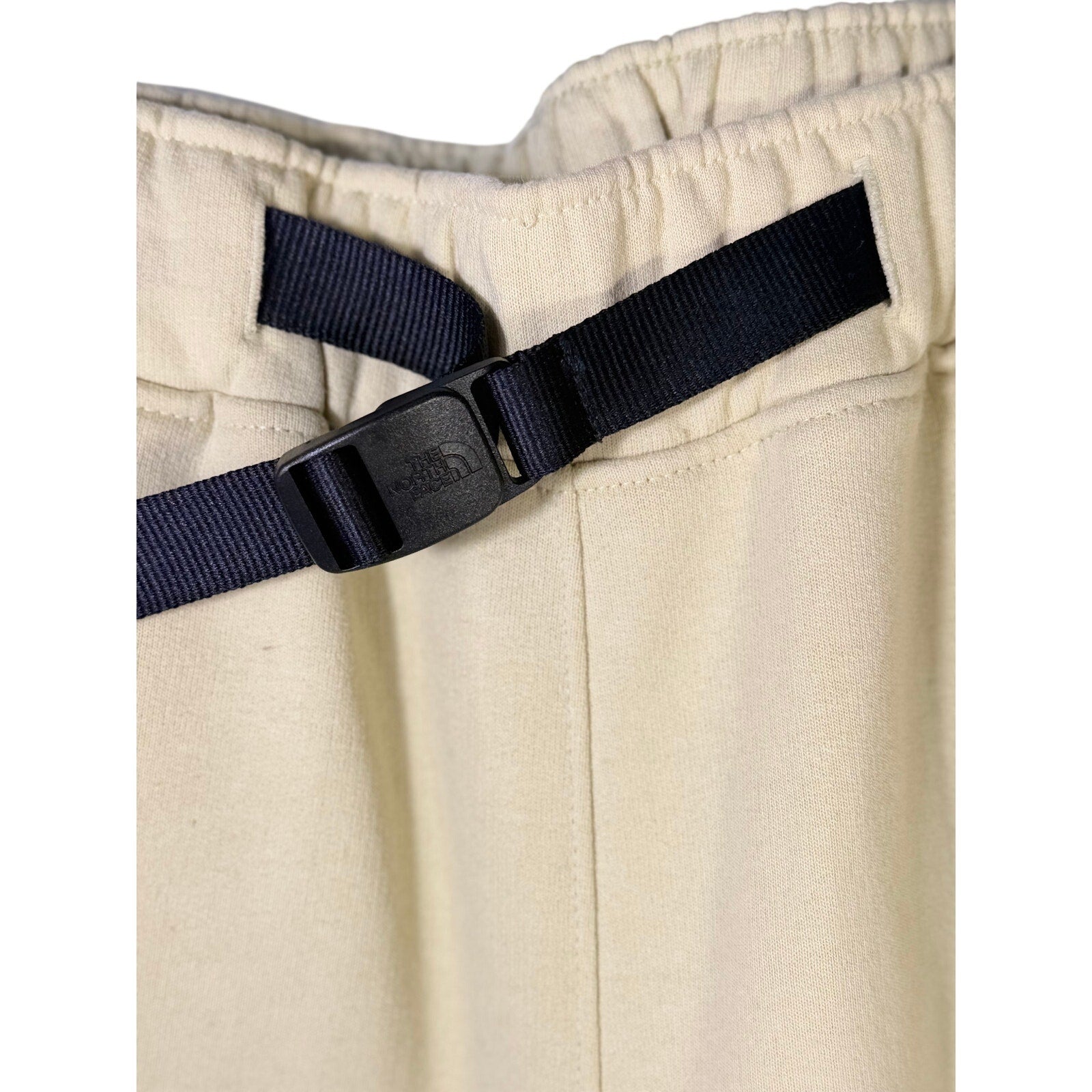 The North Face men's AXYS sweatpants in gravel beige, size small, showing the relaxed fit and branding details.