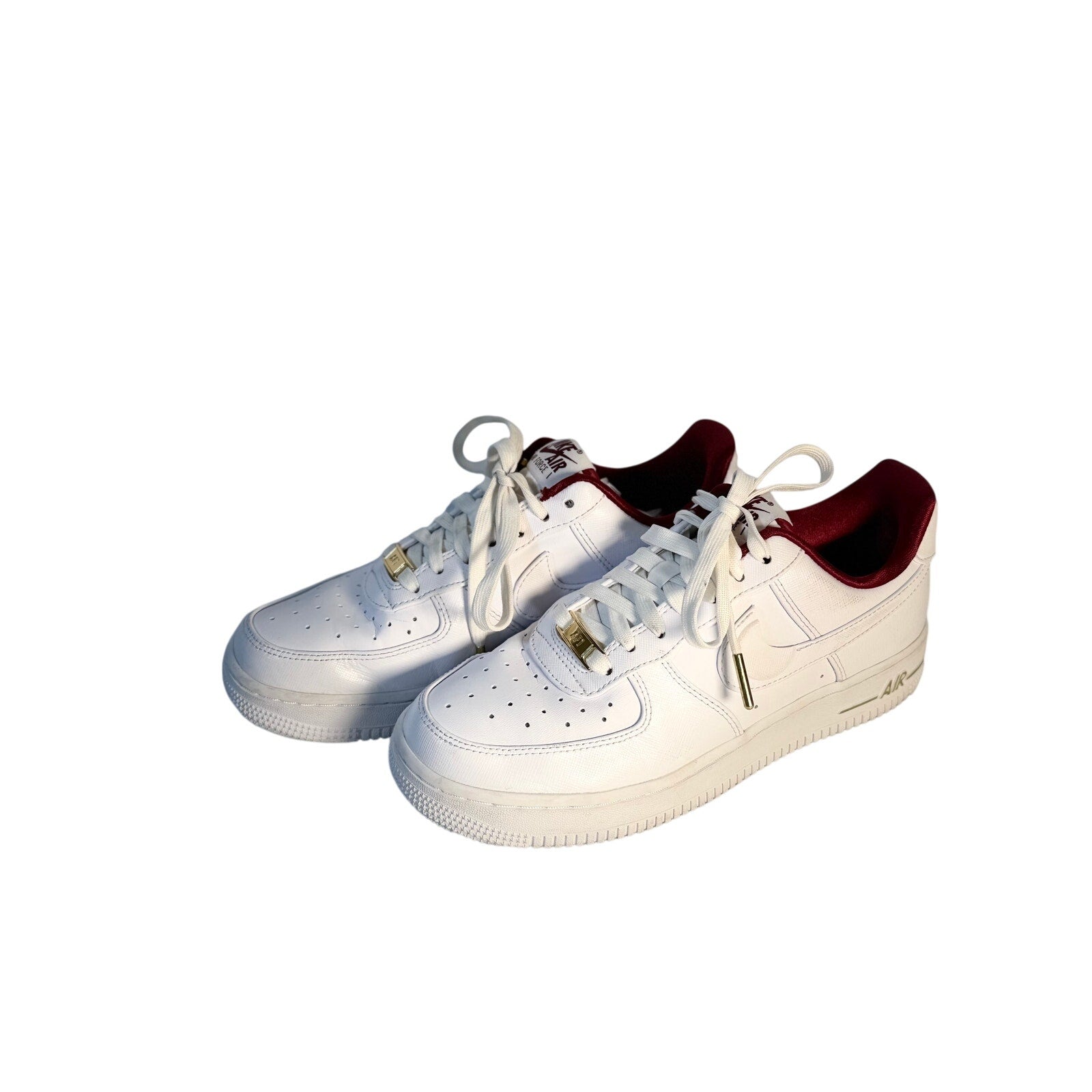 Nike Air Force 1 '07 LV8 men's white sneakers with red accents, showing the side view and classic design details.