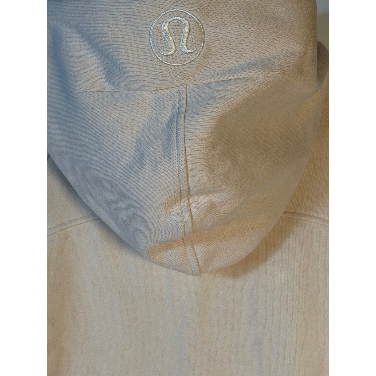 Lululemon women's cream scuba half-zip hoodie in oversized fit, size XL/XXL, displayed as a cozy, stylish pullover on a model.