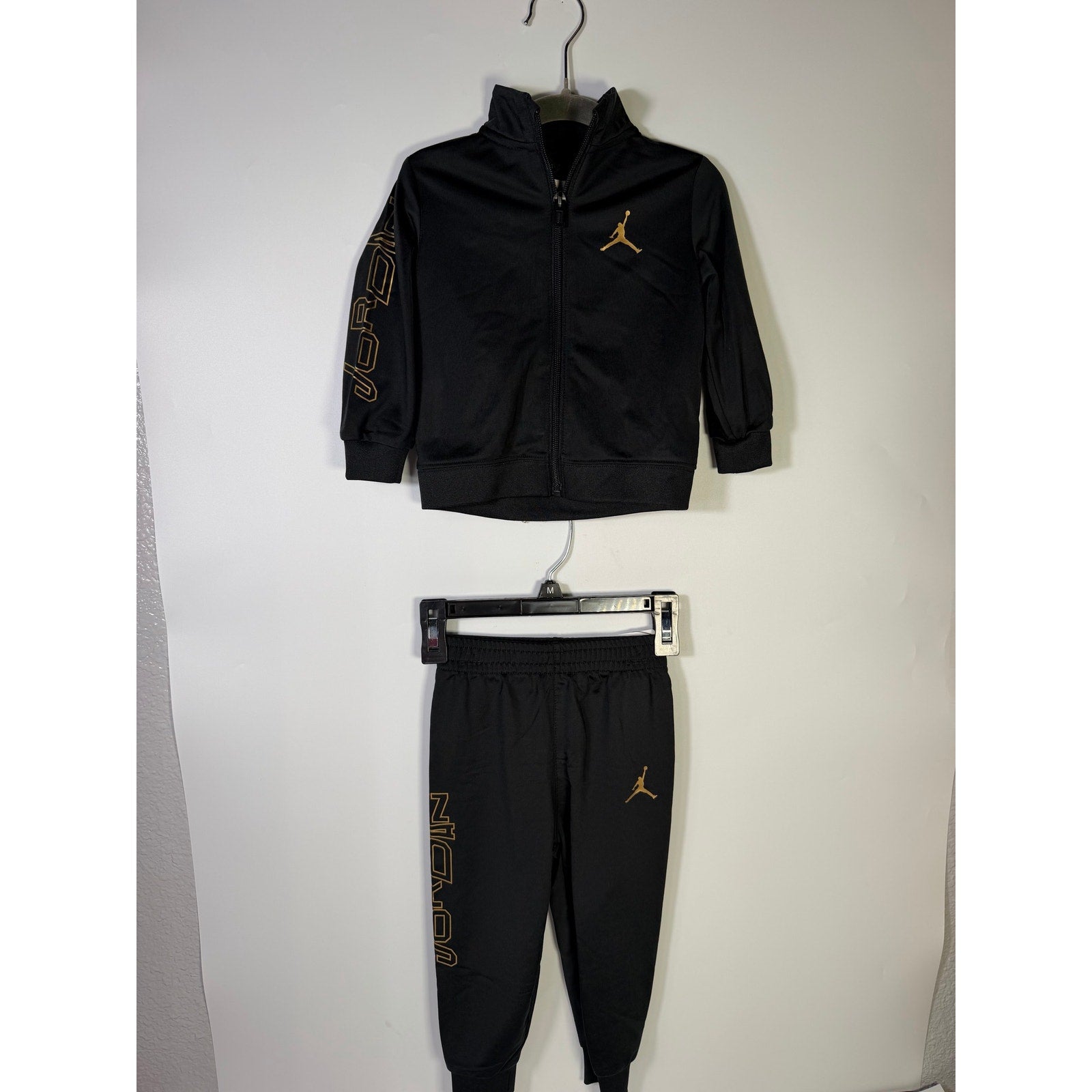 Jordan baby boys 2-piece black and gold track jacket and jogger set, size 18 months, new with tags.