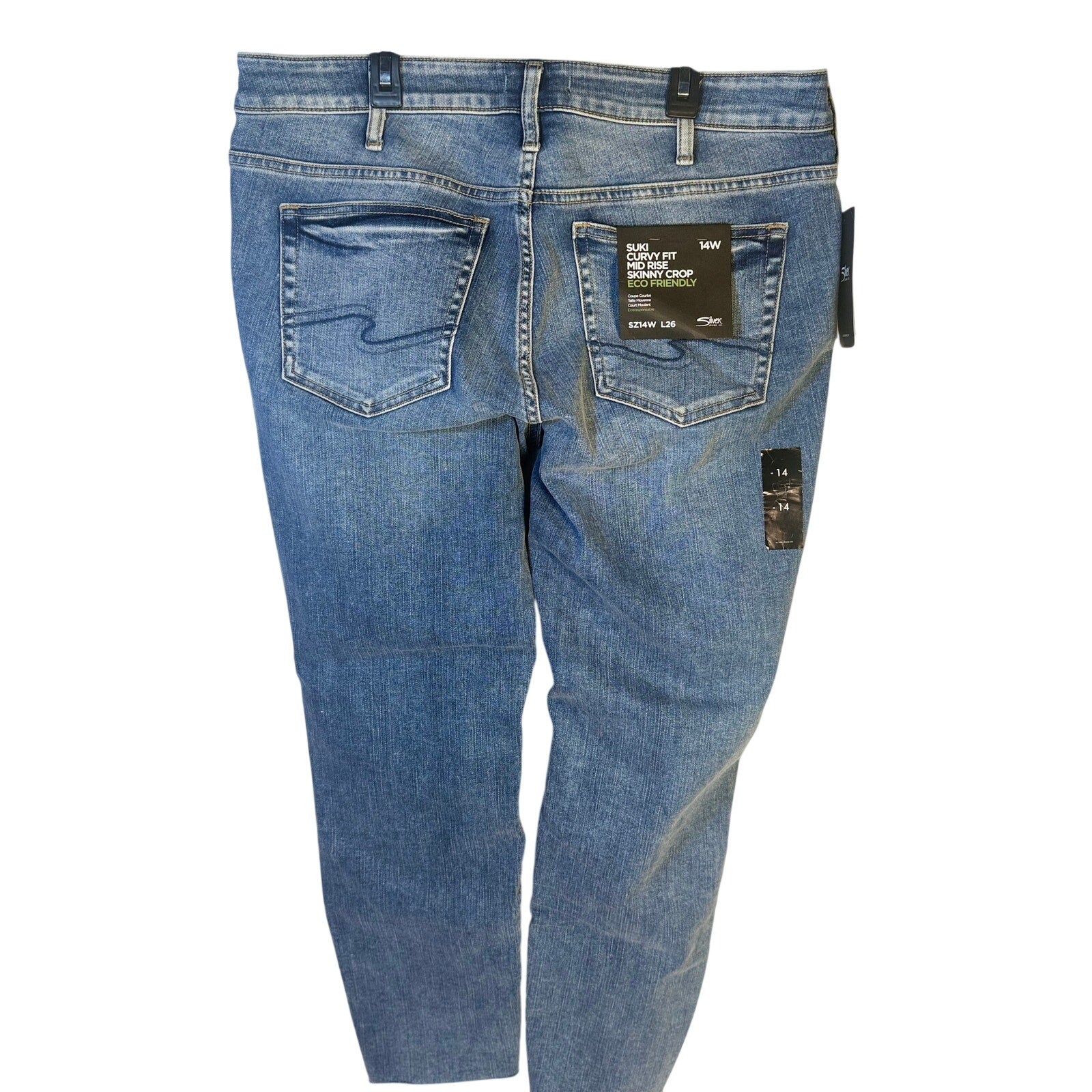 Silver Jeans Co. Suki curvy fit mid-rise skinny crop jeans for women, size 14W, shown folded with a light wash denim finish.