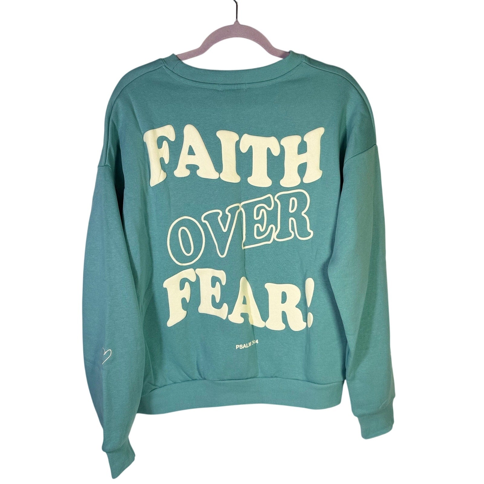 Green Seventh & Sunset Faith Over Fear Christian crewneck sweatshirt with bold text, medium size, displayed on a plain background.