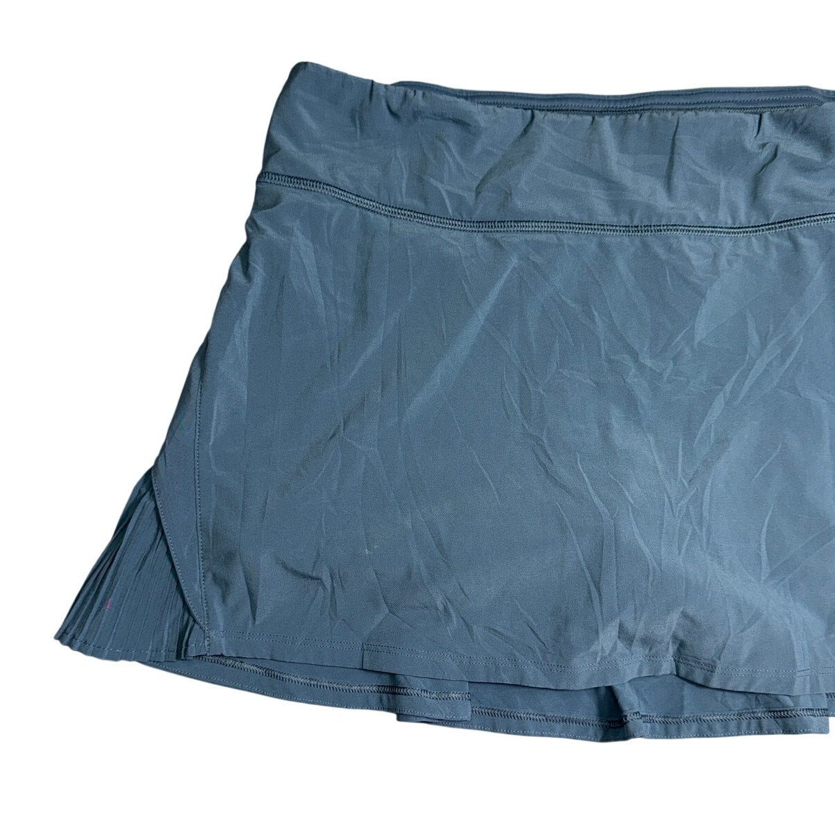 Lululemon Athletica women's ruffle pleated skirt in size 8 with back pocket, shown laid flat on a white background.