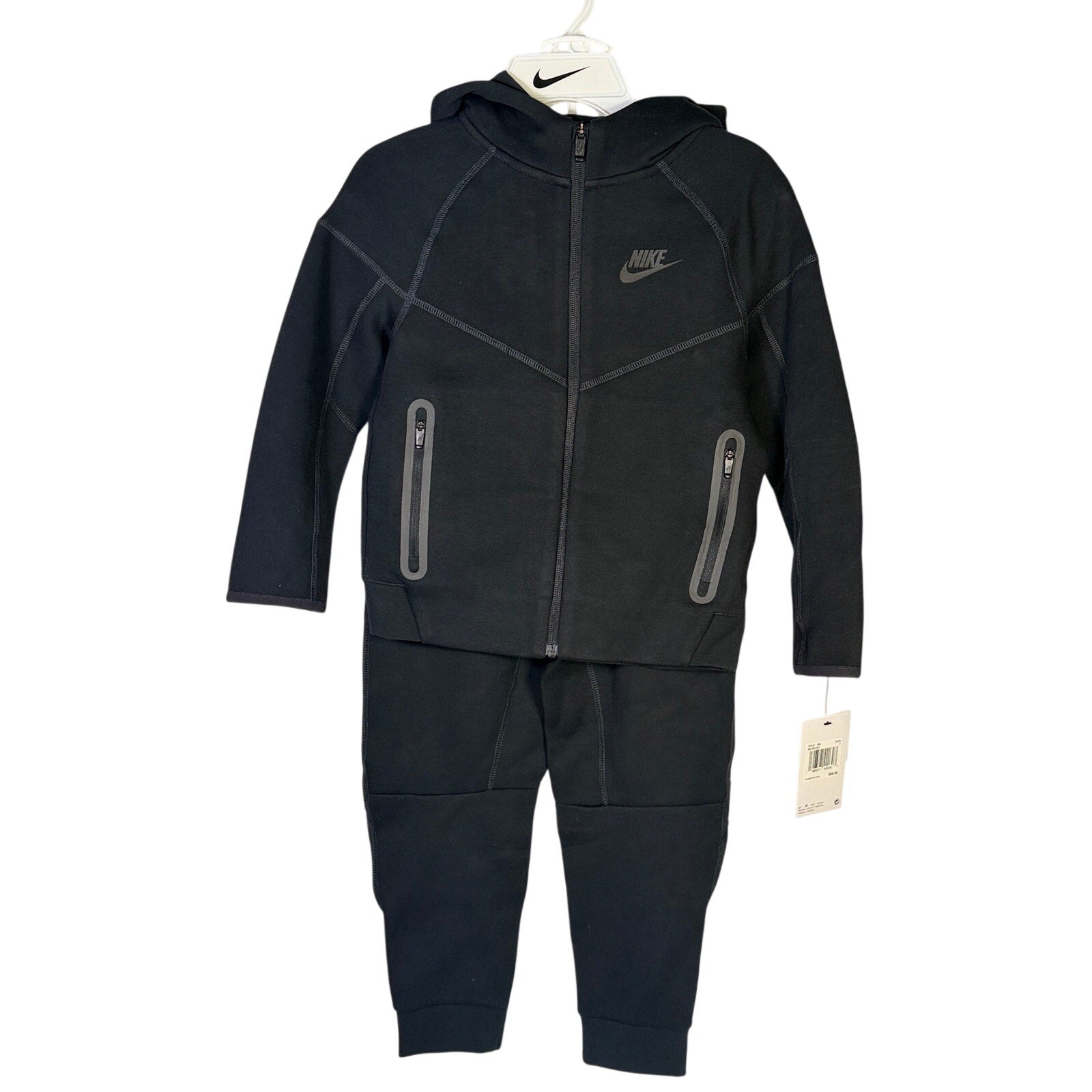 Nike Kids Tech Fleece full-zip hoodie and jogger set in black, size 7, featuring Nike branding and comfortable fleece fabric.