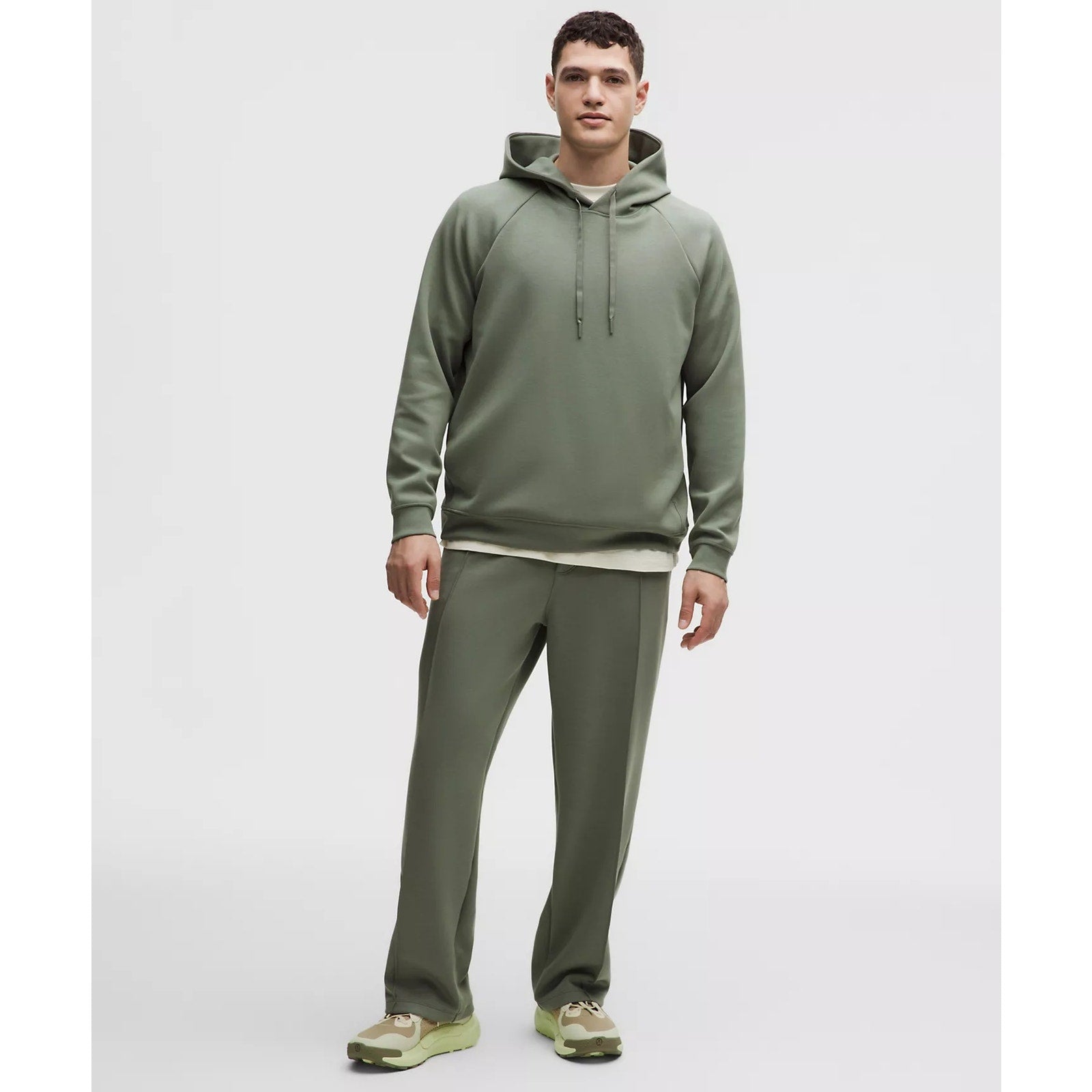 Men's green Lululemon Smooth Spacer pullover hoodie, medium size, showing front view with soft fabric texture.
