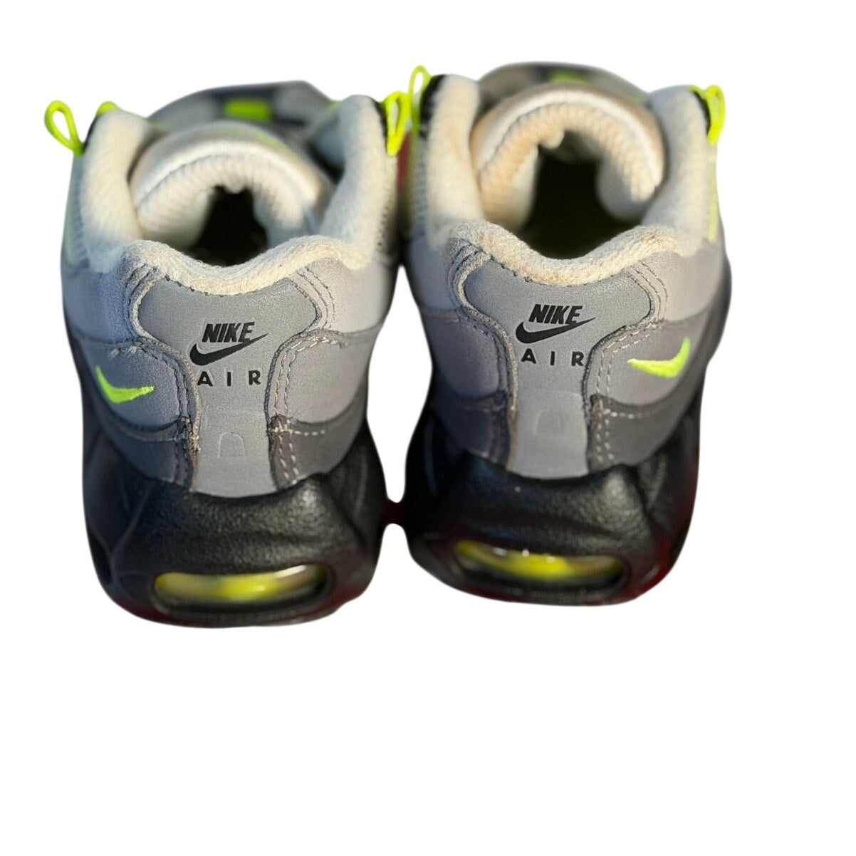 Nike Air Max 95 toddler sneakers in gray, volt, and black with sporty running shoe design for kids.