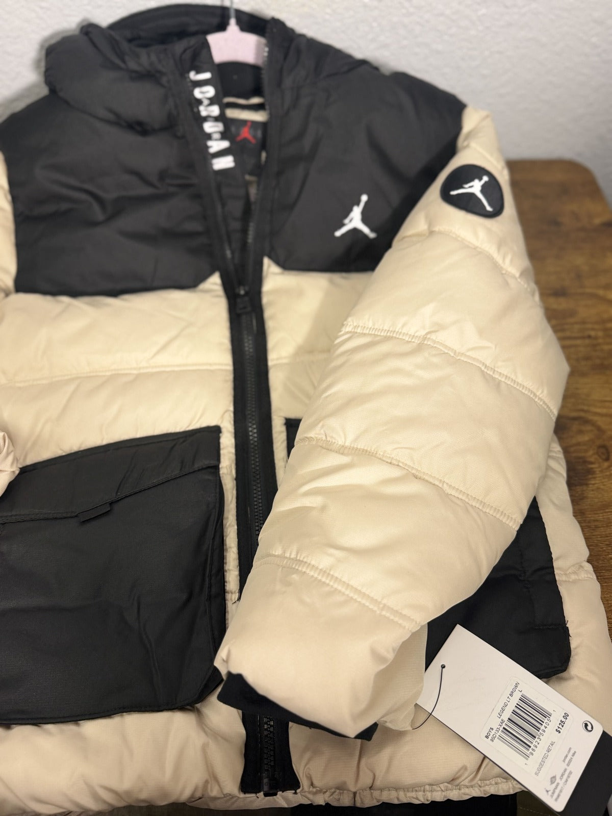 Jordan Jumpman hooded puffer jacket for boys in Legend Light Brown and Black, featuring a padded design with hood and zip closure.