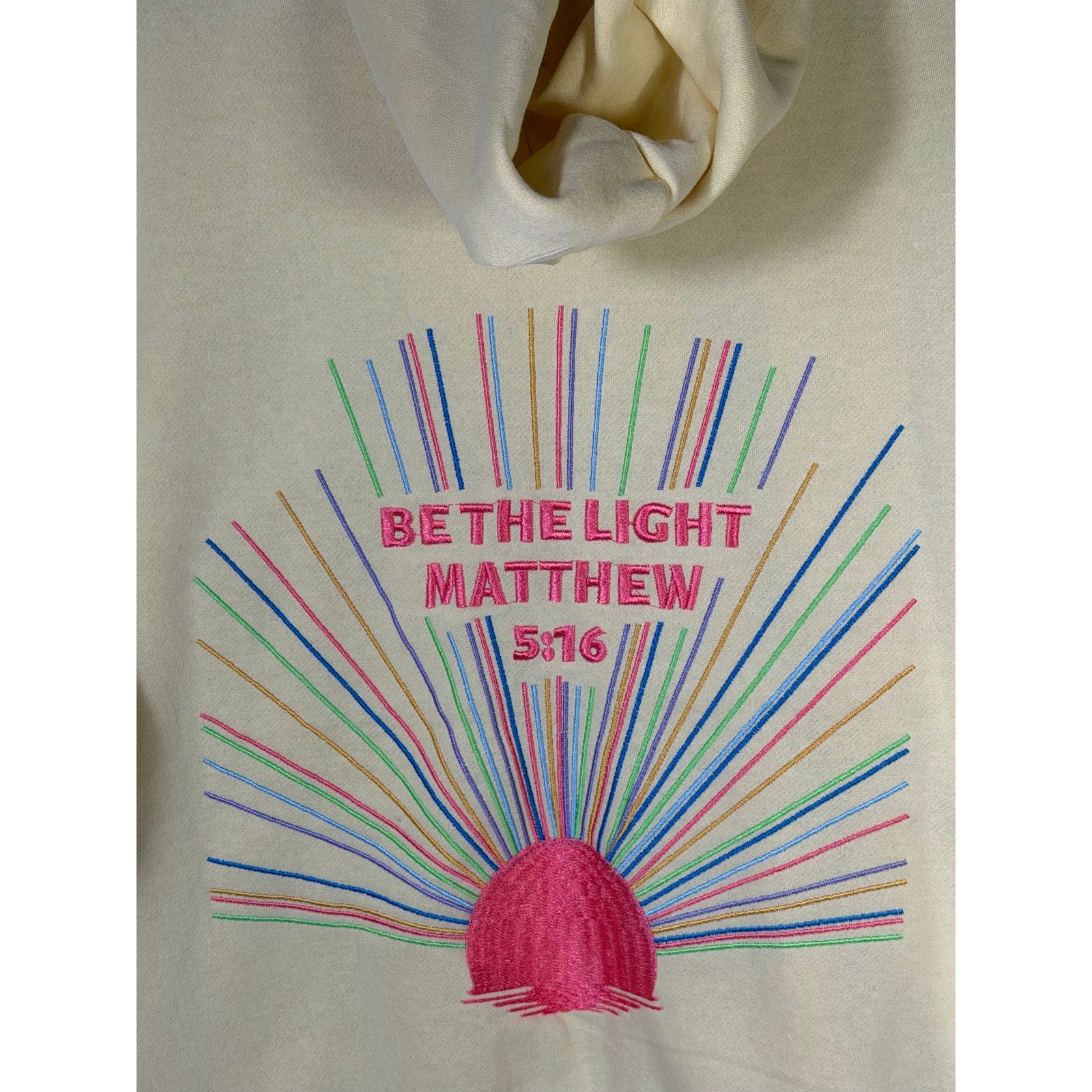 Yellow Christian hoodie by Faded Rose with "Be The Light" and Matthew 5:16 printed on the front, size large, casual fit.