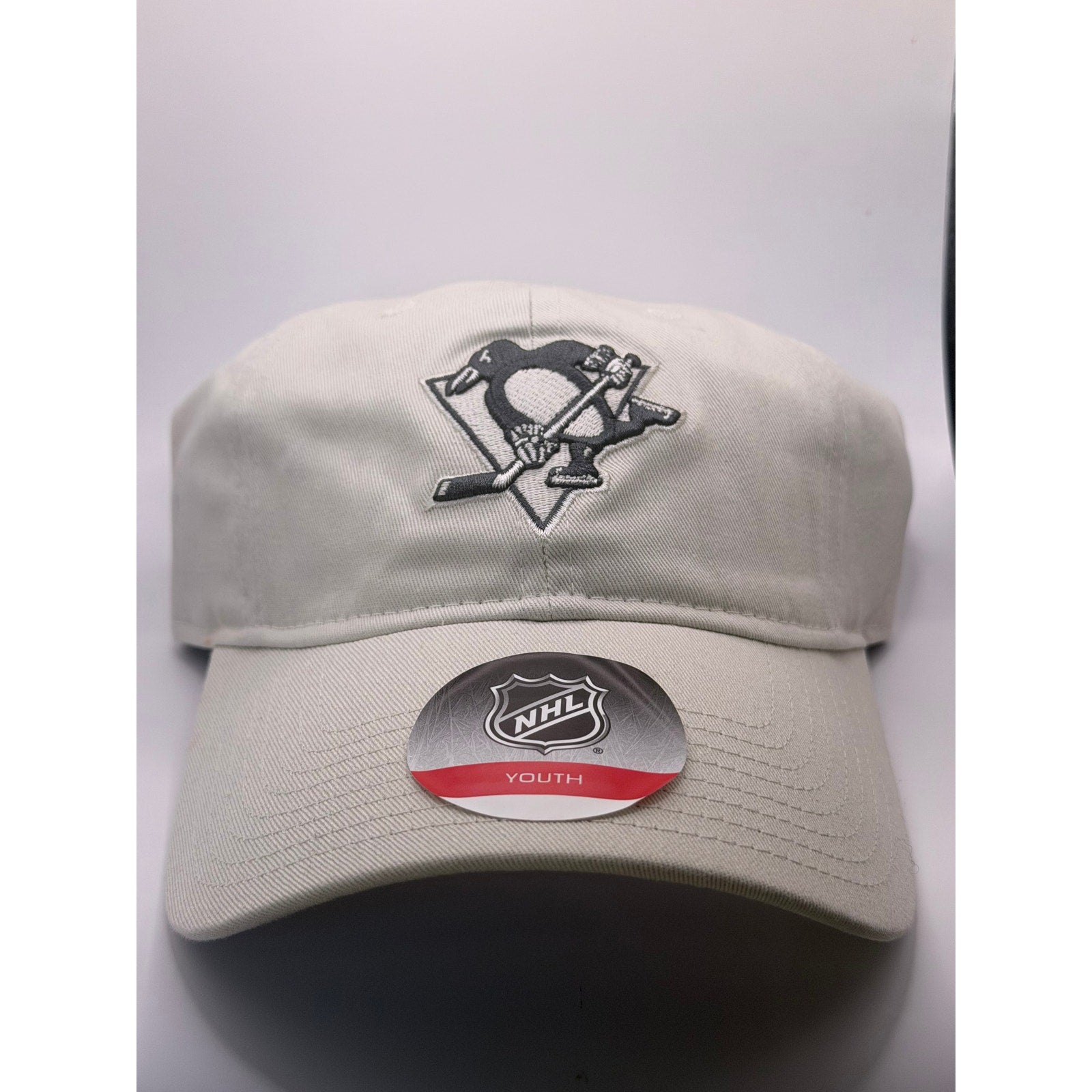 NHL Pittsburgh Penguins youth adjustable strapback hat in beige, featuring team logo, one size fits most, new with tags.