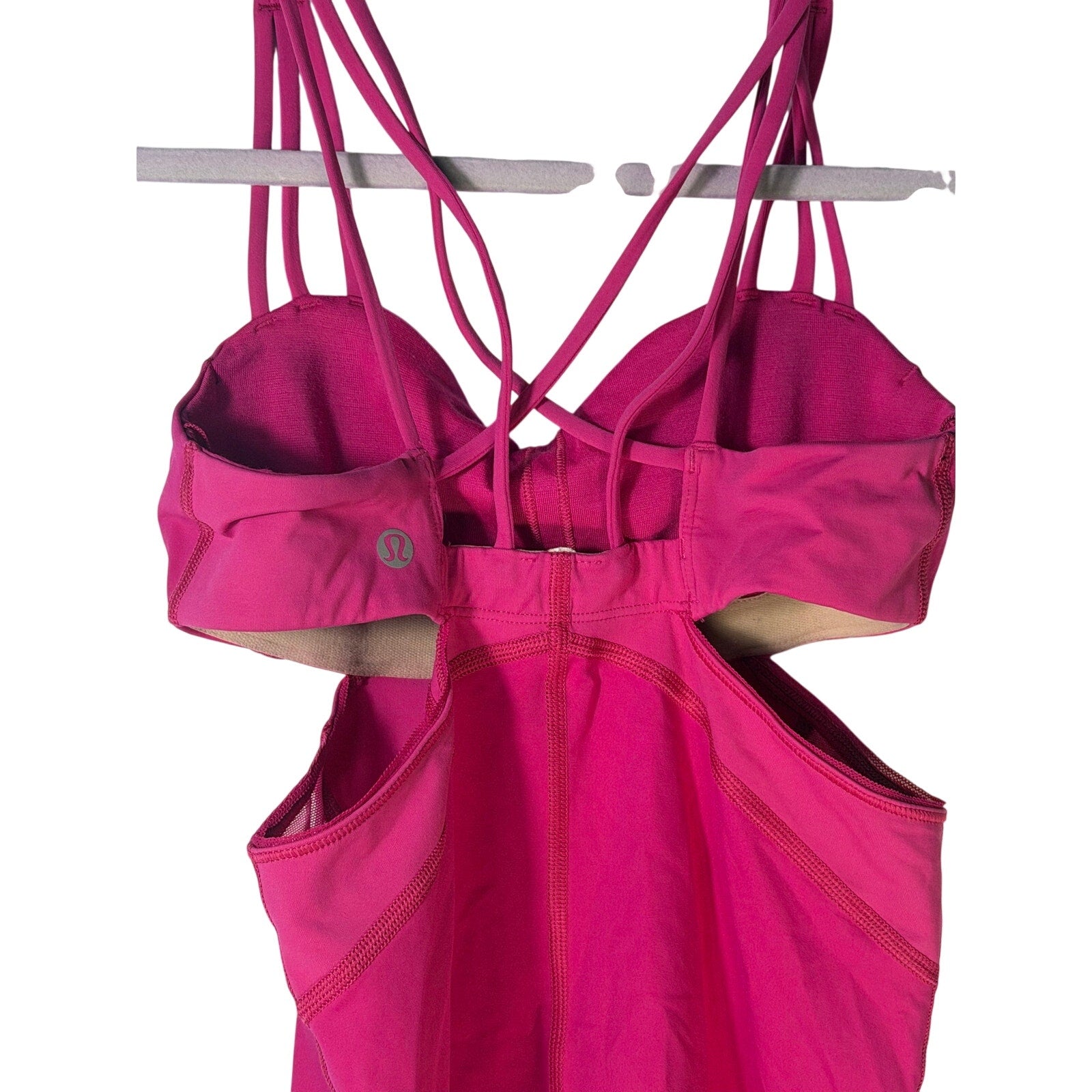 Lululemon women's magenta strappy cutout athletic tank top, size 2, pre-owned, with stylish open back and supportive fit.