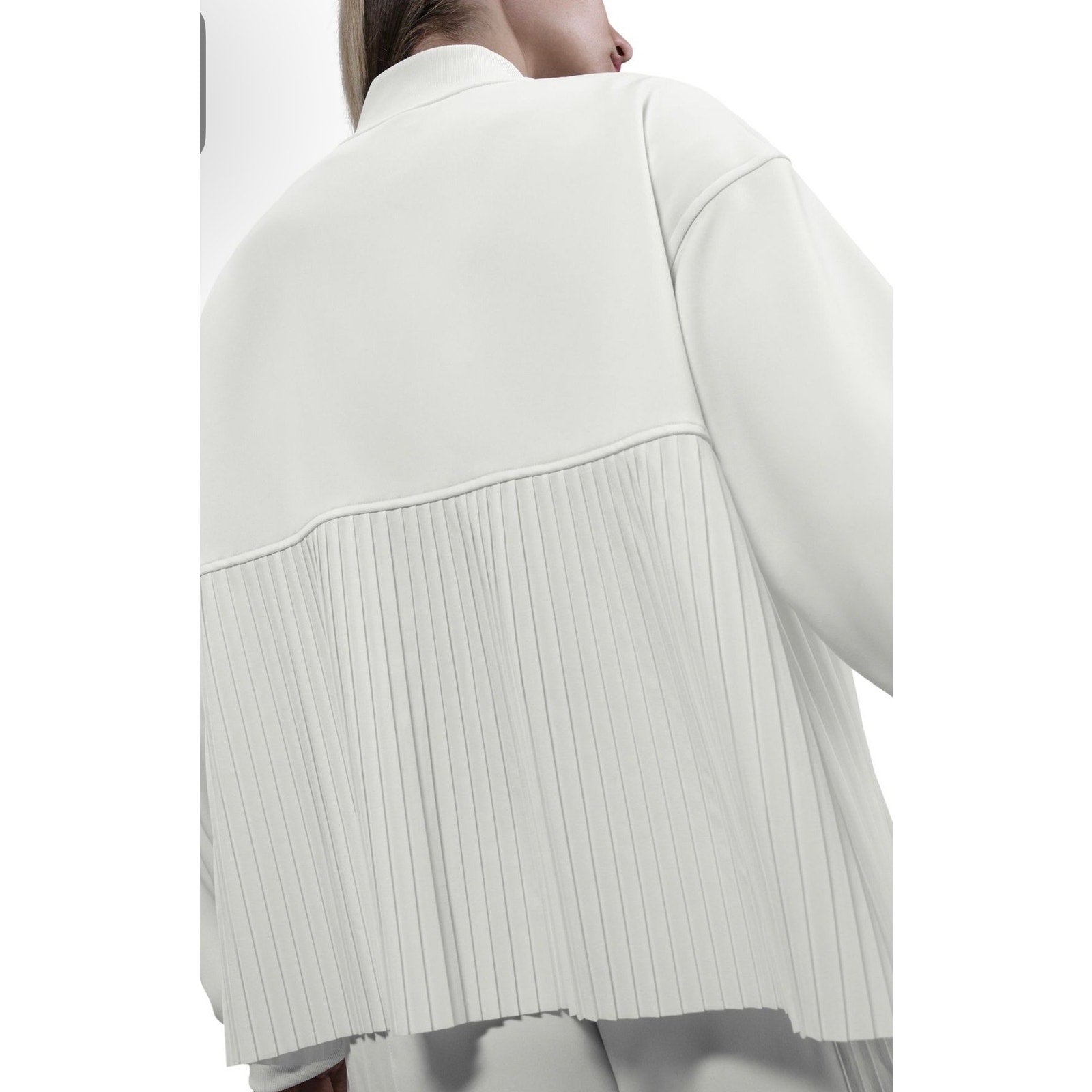 Nike women's white pleated bomber jacket full zip, size M, stylish and lightweight, shown on a hanger.
